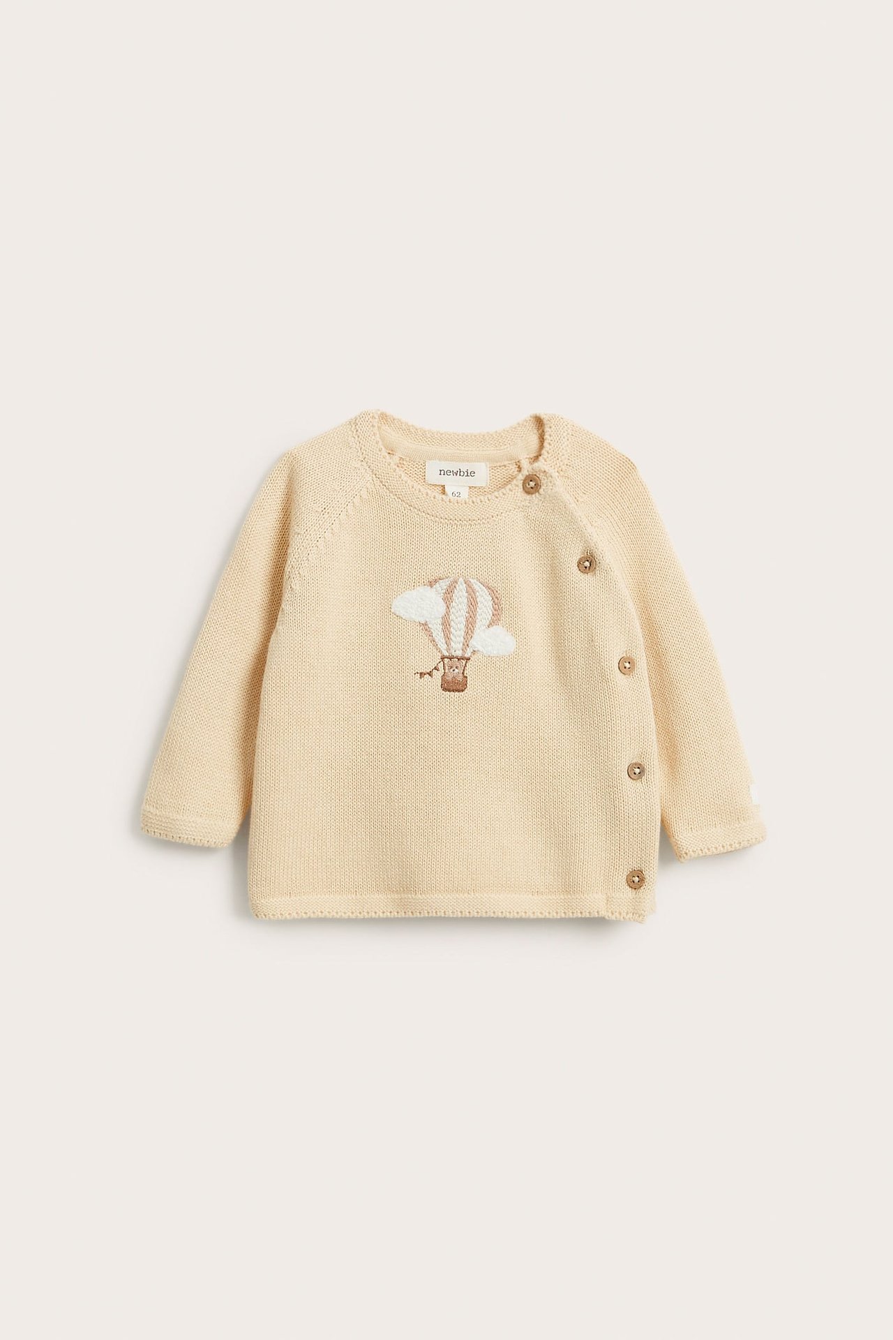 Front view of a baby light yellow knitted cardigan with embroidered hot air balloon and wooden side buttons.