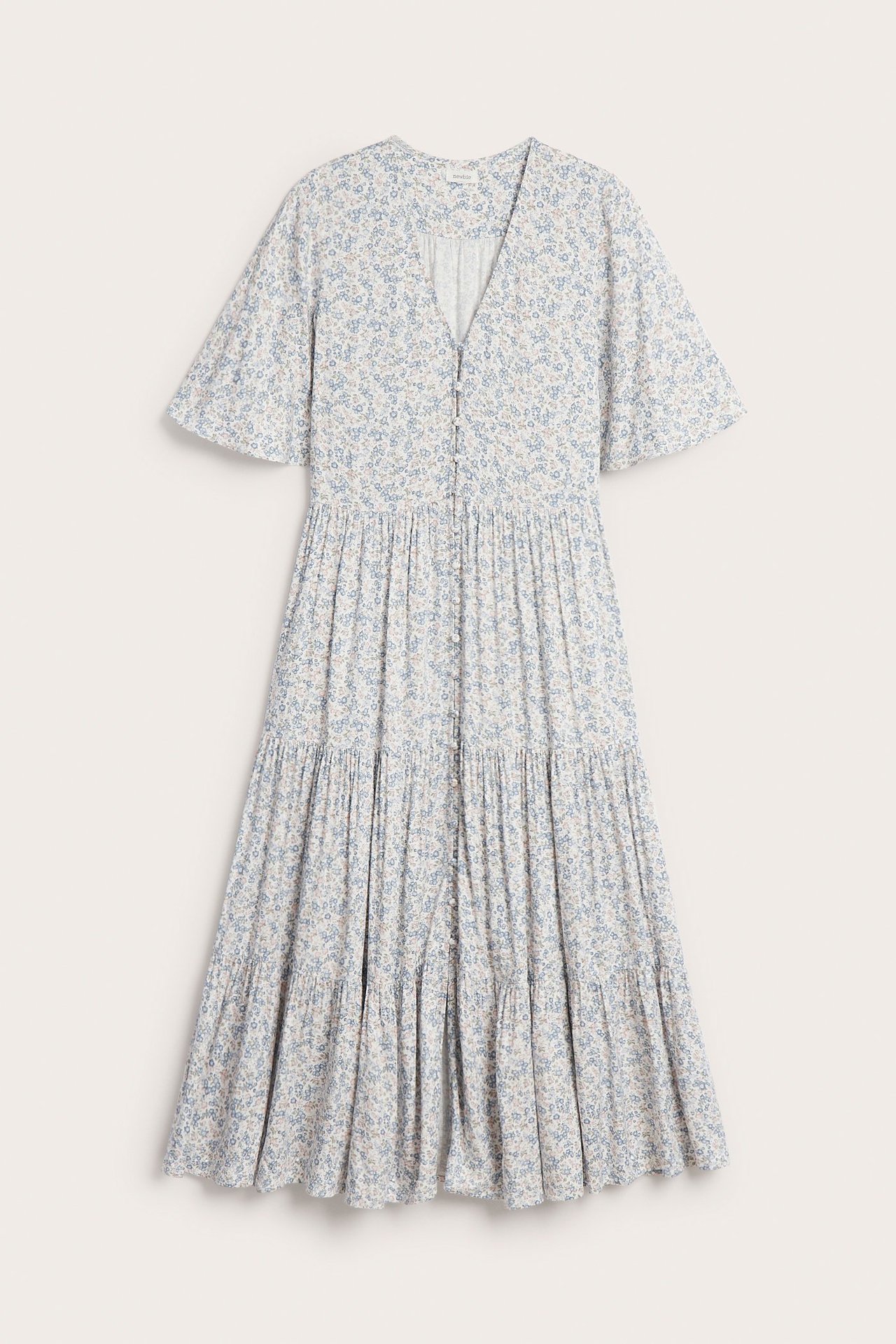 Front view: off-white V-neck midi dress, short sleeves, small blue floral pattern, front buttons.