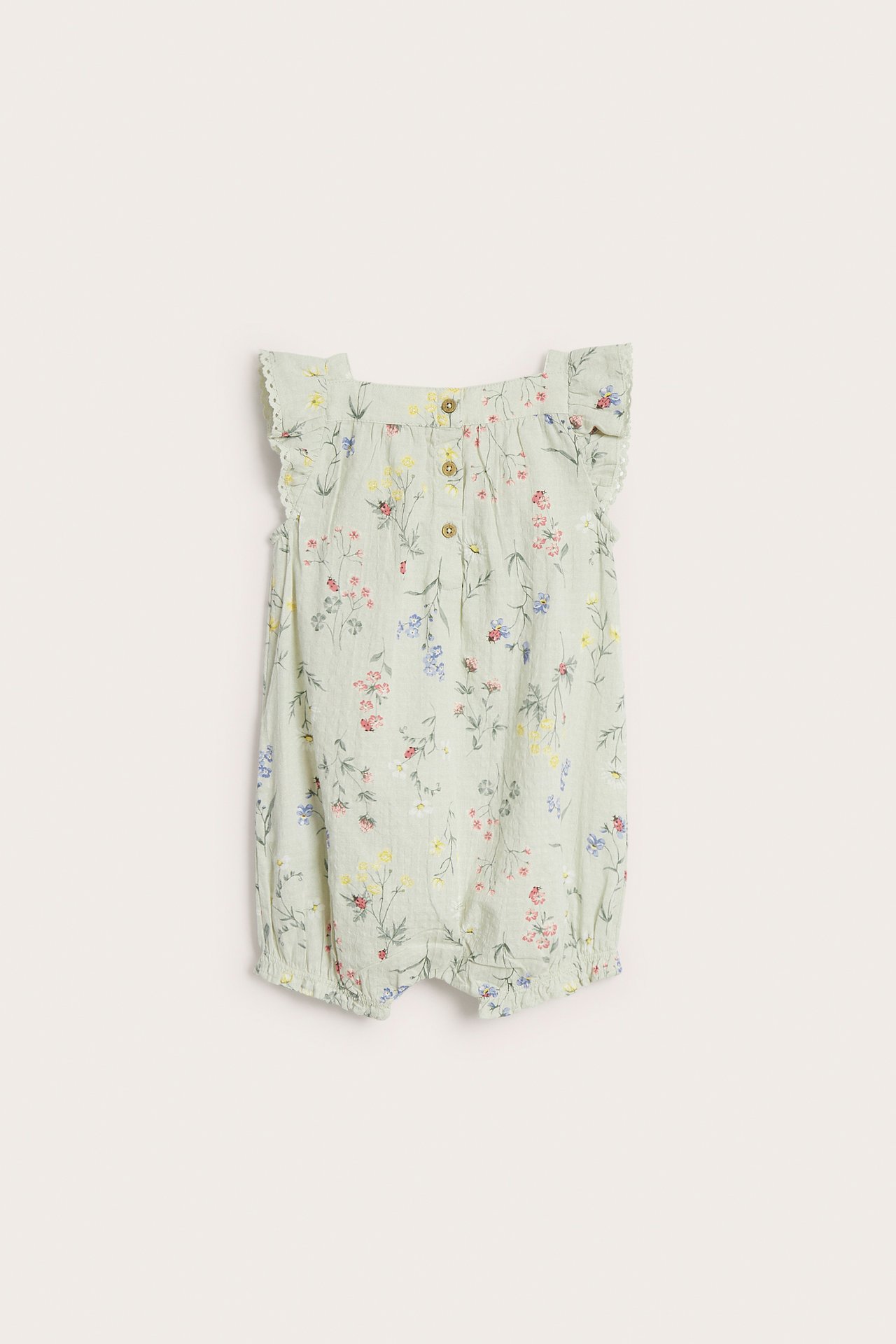 Front view of a light green woven baby romper with floral print, ruffle sleeves, and front buttons.