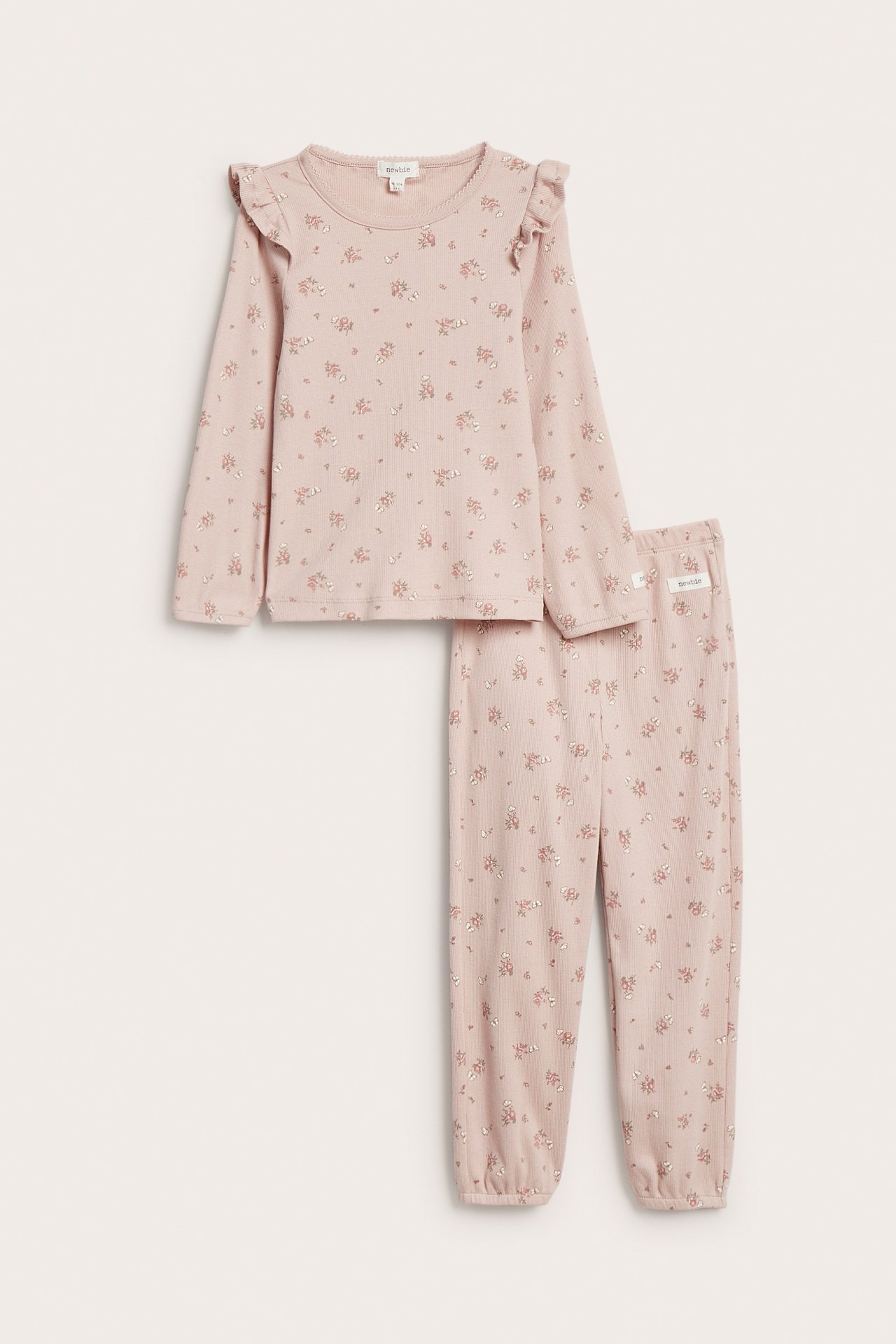 Front view: Kid's pink floral ribbed jersey pajama set with ruffled shoulders and elastic cuffs.