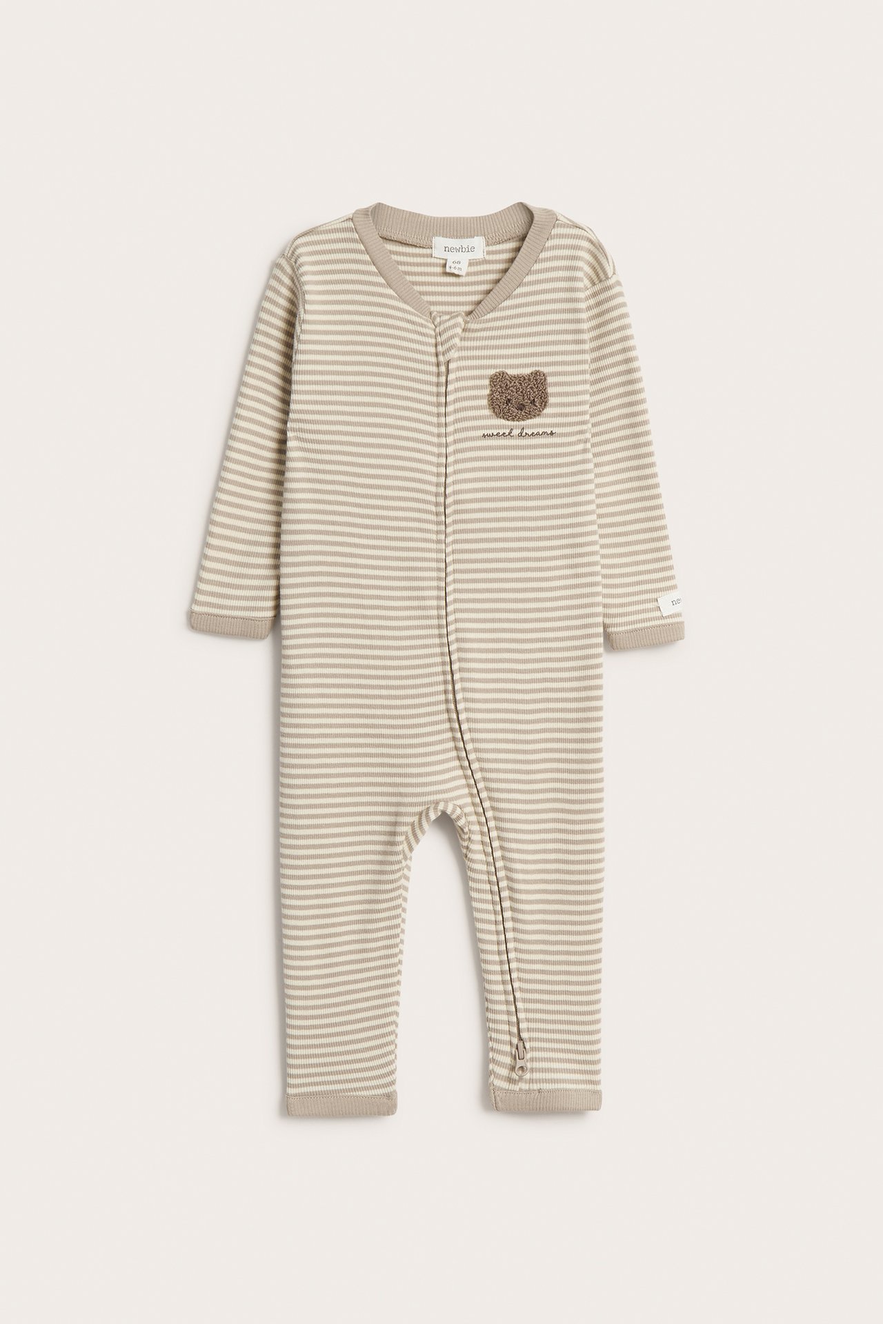 Front view of a baby's beige striped ribbed pajama with a two-way zipper and a teddy bear application.