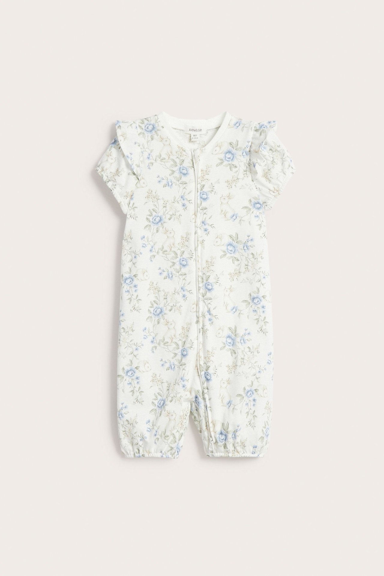 Front view of an off-white baby floral print short-sleeved pyjamas with ruffles and snap buttons.
