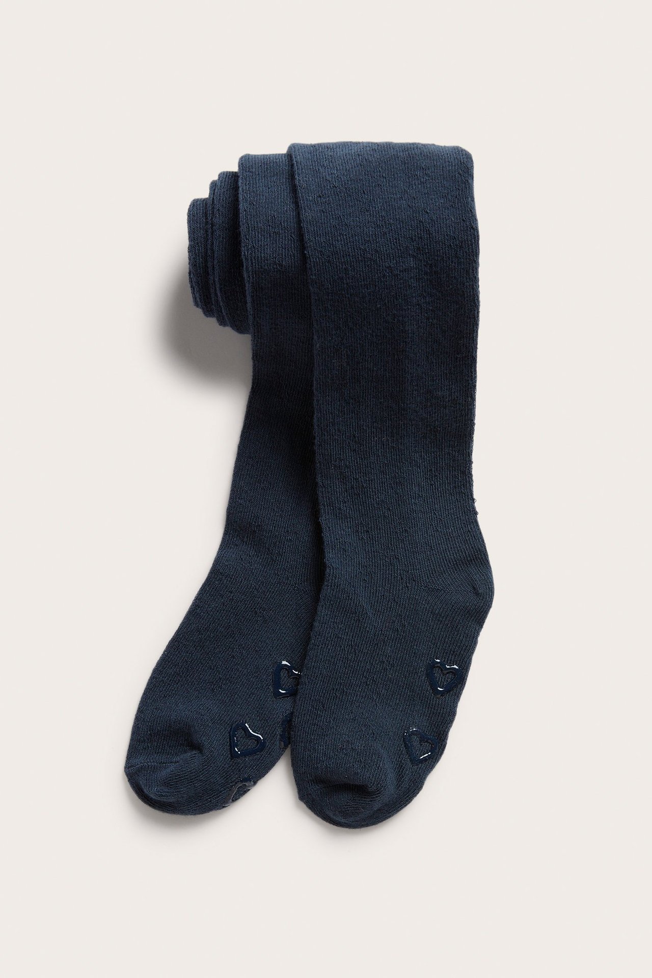 Front view of folded dark blue tights with anti-slip heart patterns on the soles.