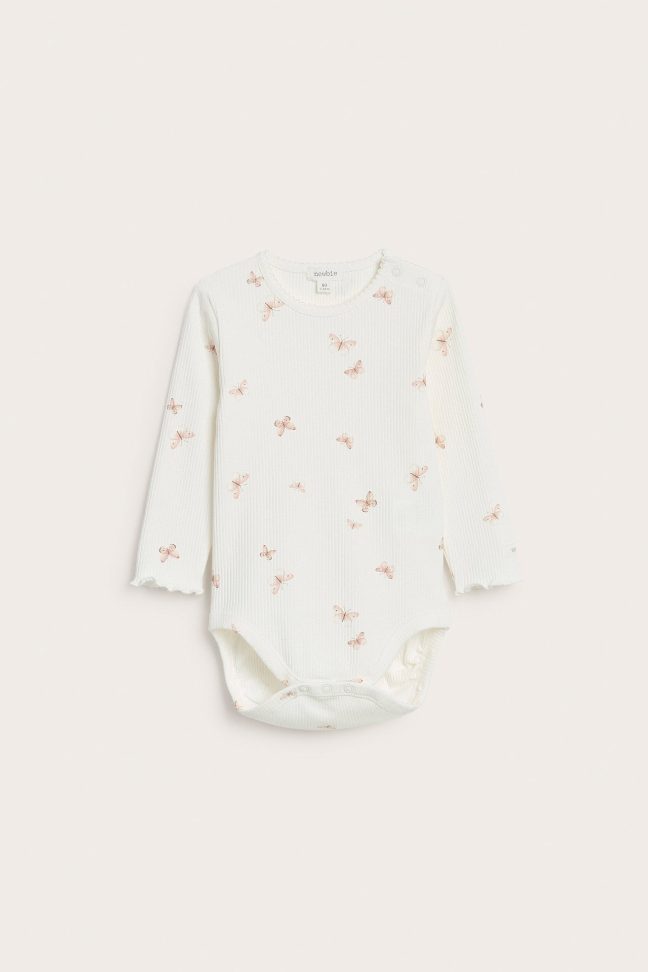 Front view of an off-white ribbed baby bodysuit with a butterfly pattern, picot neck, and snap buttons.