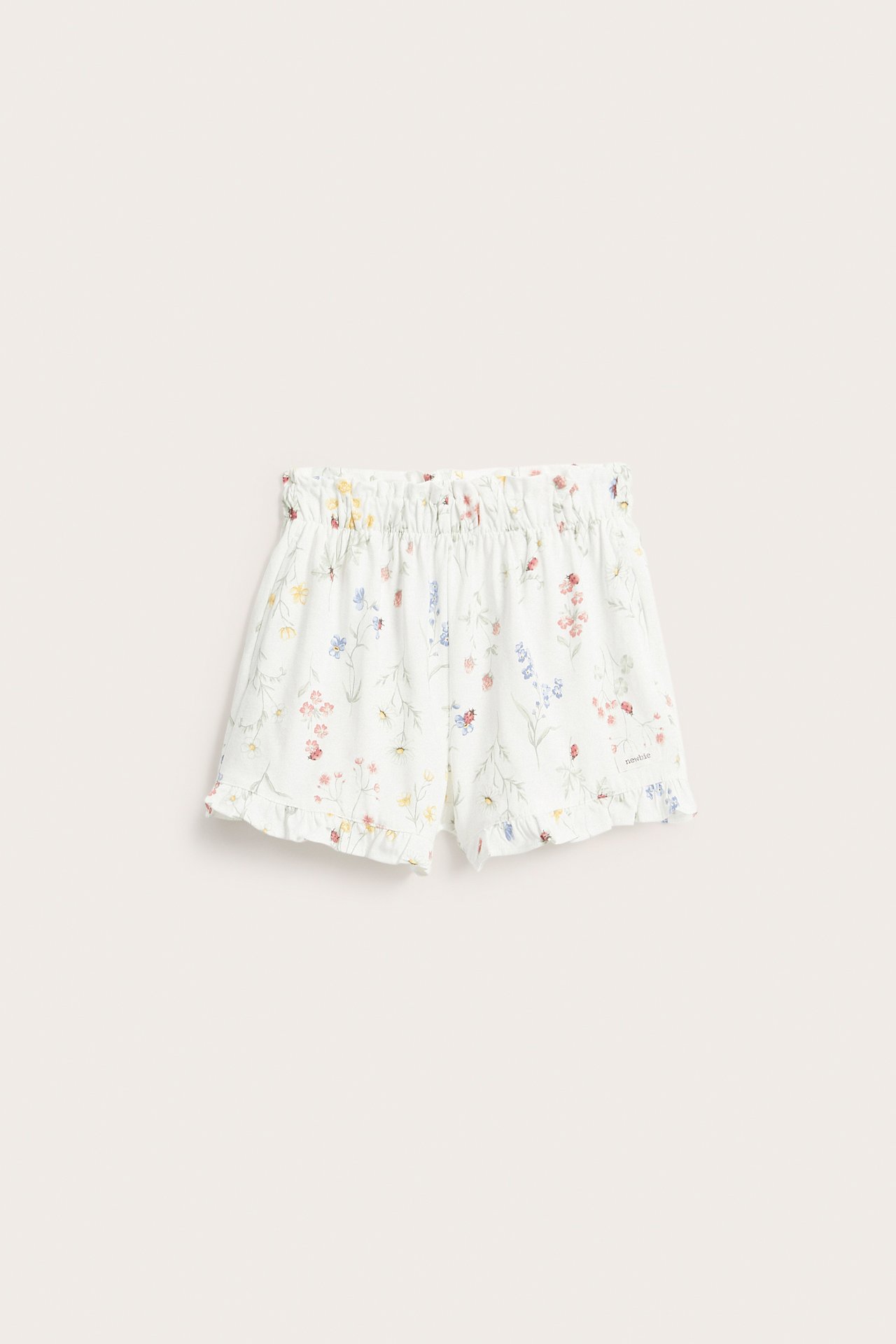 Front view: Off-white jersey shorts with floral, ladybug print, elasticated waist, ruffled legs.