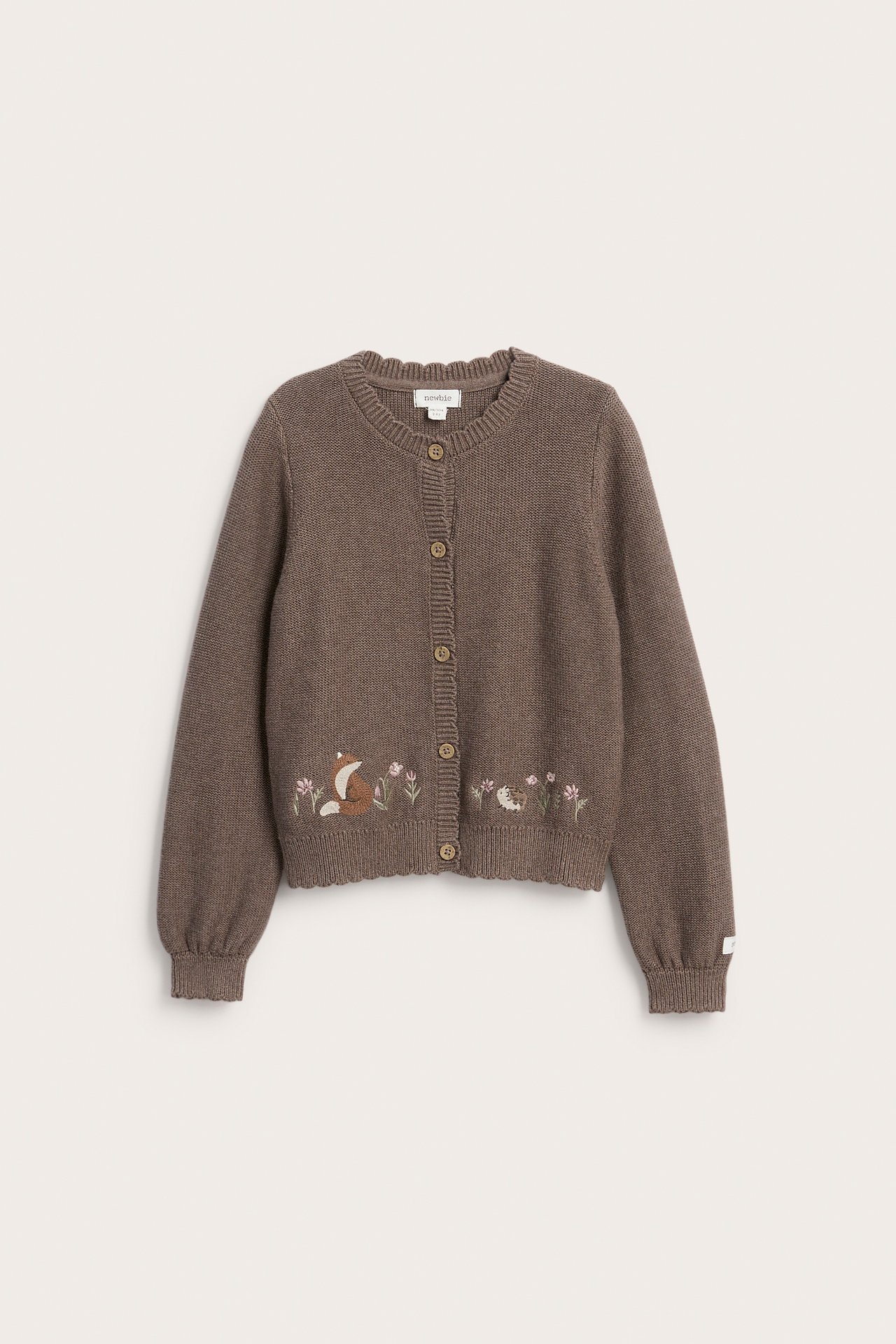 Front view of a kid's brown knitted cardigan with embroidered fox, hedgehog, and flowers.