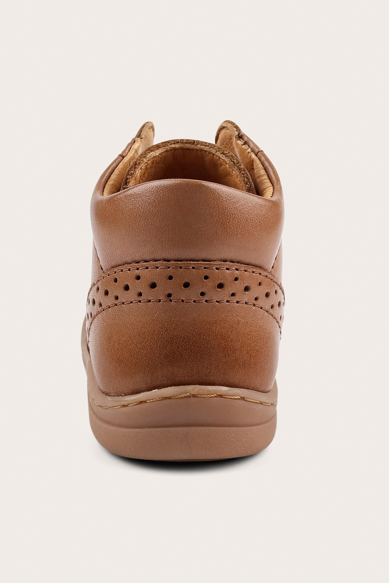 Back view of a brown leather baby first walker shoe with a textured finish and perforated detailing.