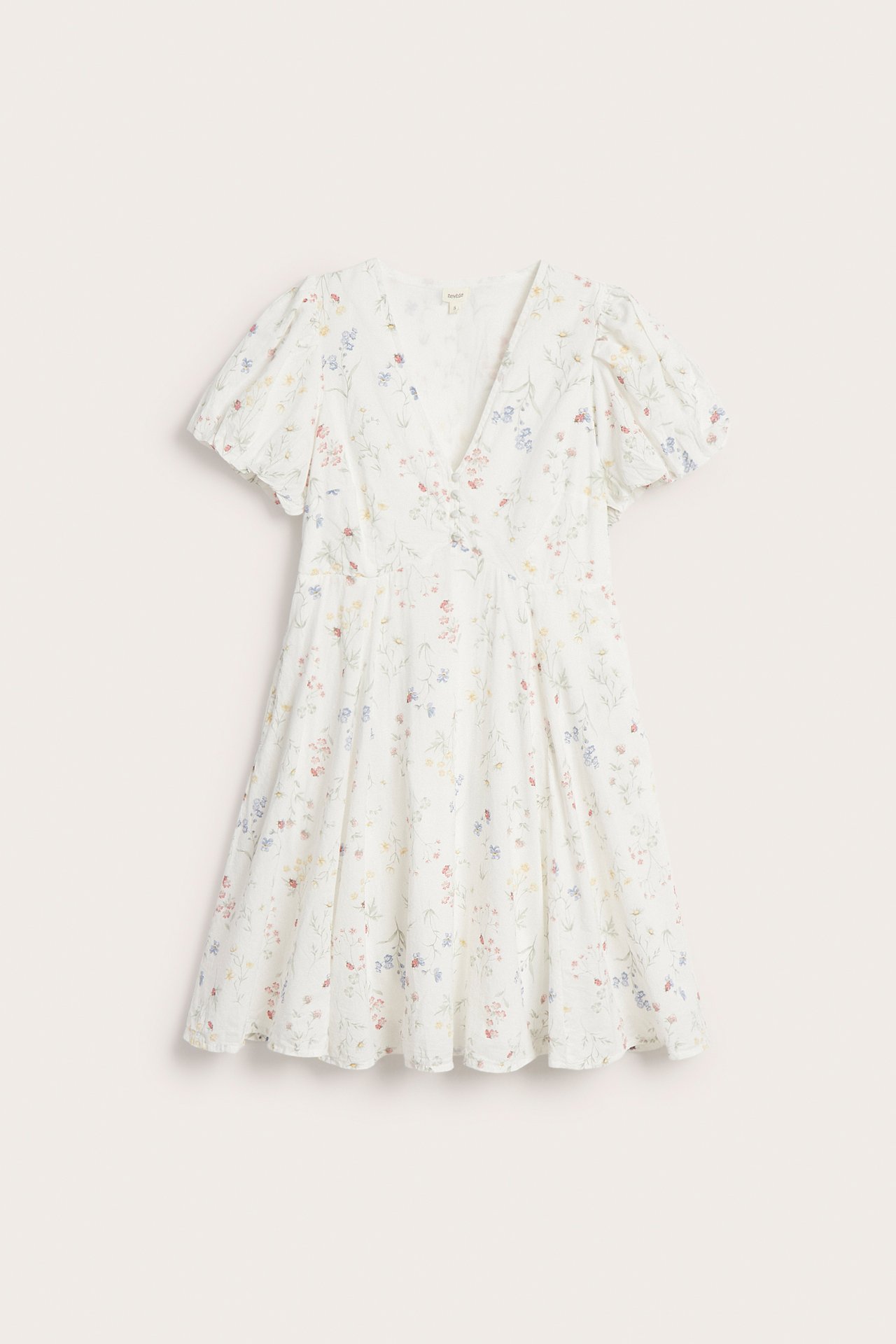 Front view of an off-white floral cotton short dress with a V-neck and short puff balloon sleeves.