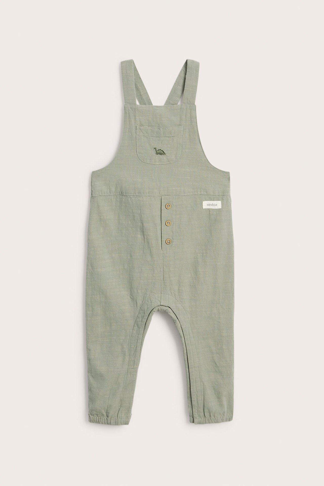 Front view: Baby's light green cotton dungarees with adjustable straps, chest pocket, and dinosaur embroidery.