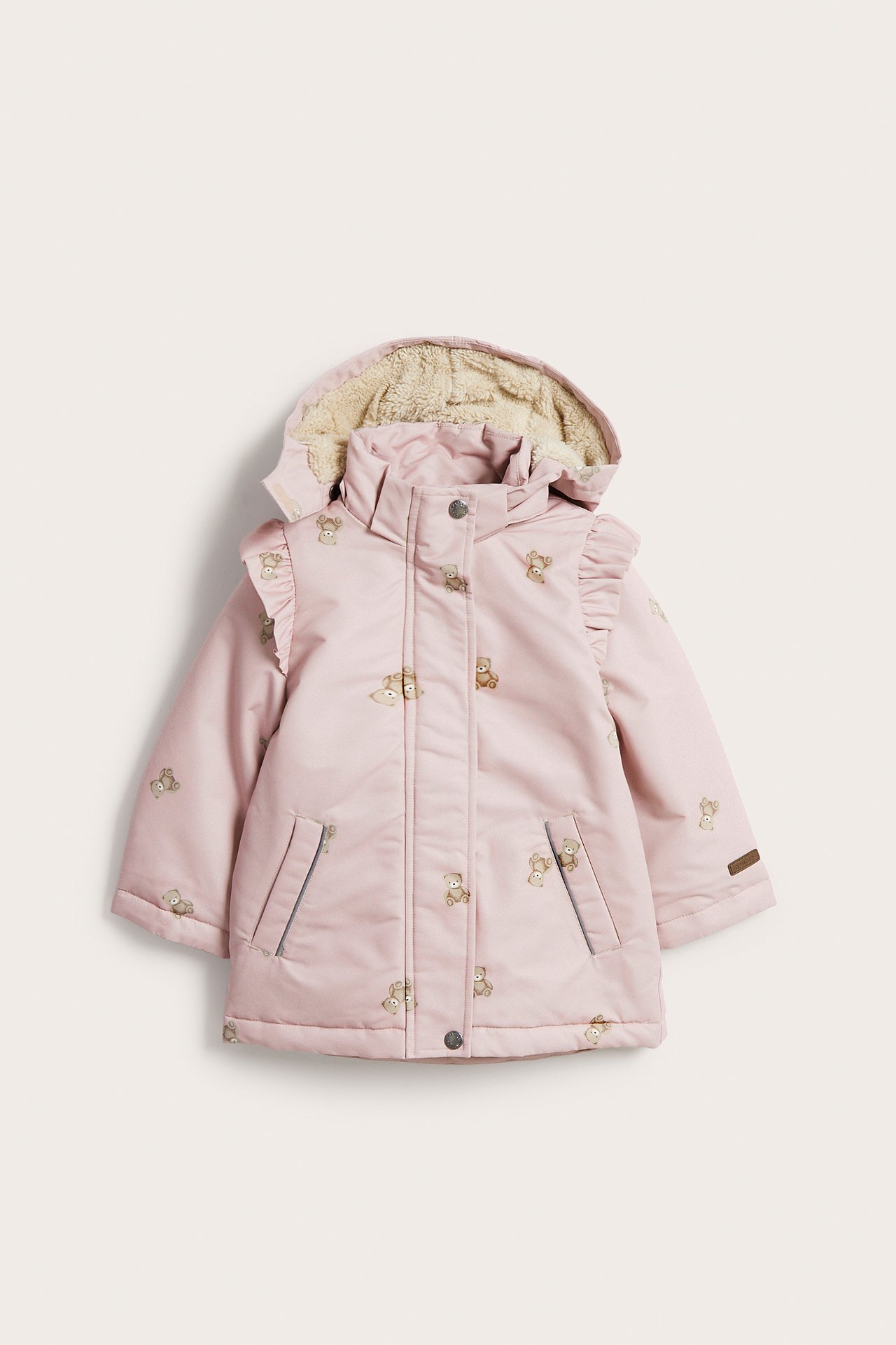 Front view of a kid's pink hooded jacket with teddy bear print and ruffle details.