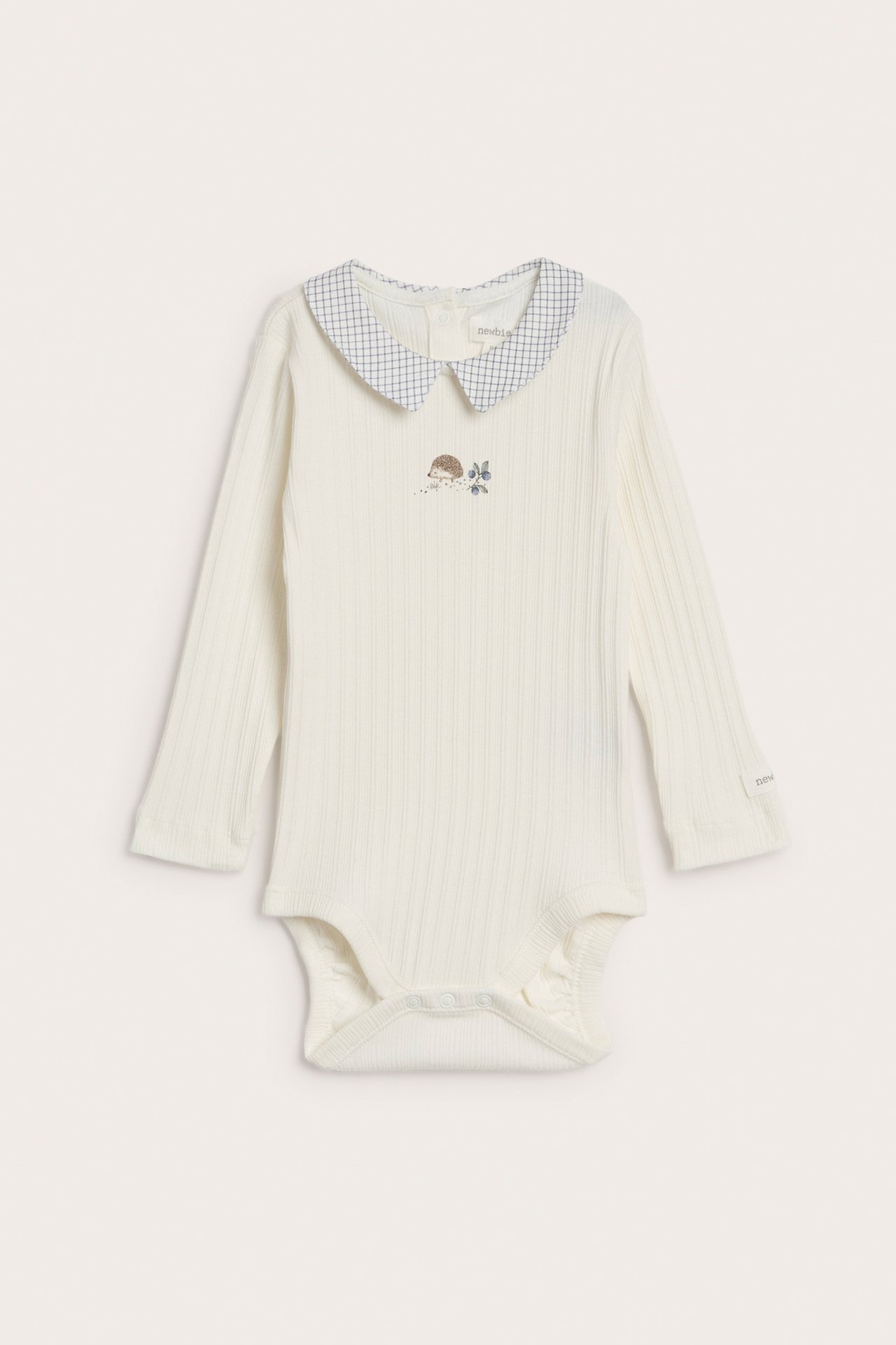 Front view of an off-white baby ribbed long-sleeved bodysuit with a blue checkered collar and hedgehog print.