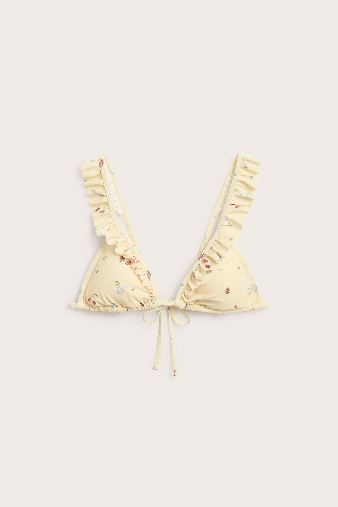 Front view of a yellow patterned triangle bikini top with ruffled straps and front tie closure.