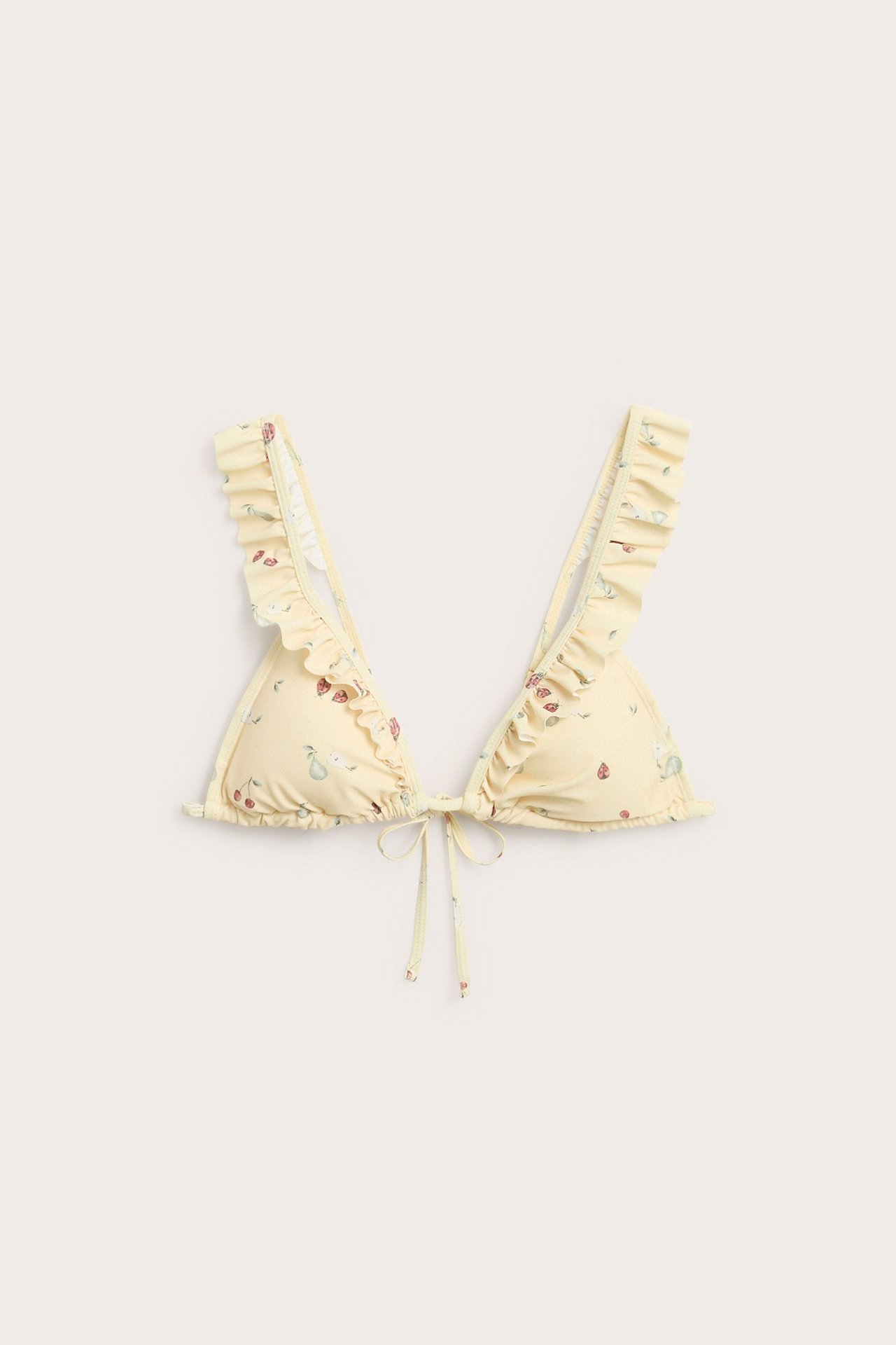 Front view of a yellow patterned triangle bikini top with ruffled straps and front tie closure.