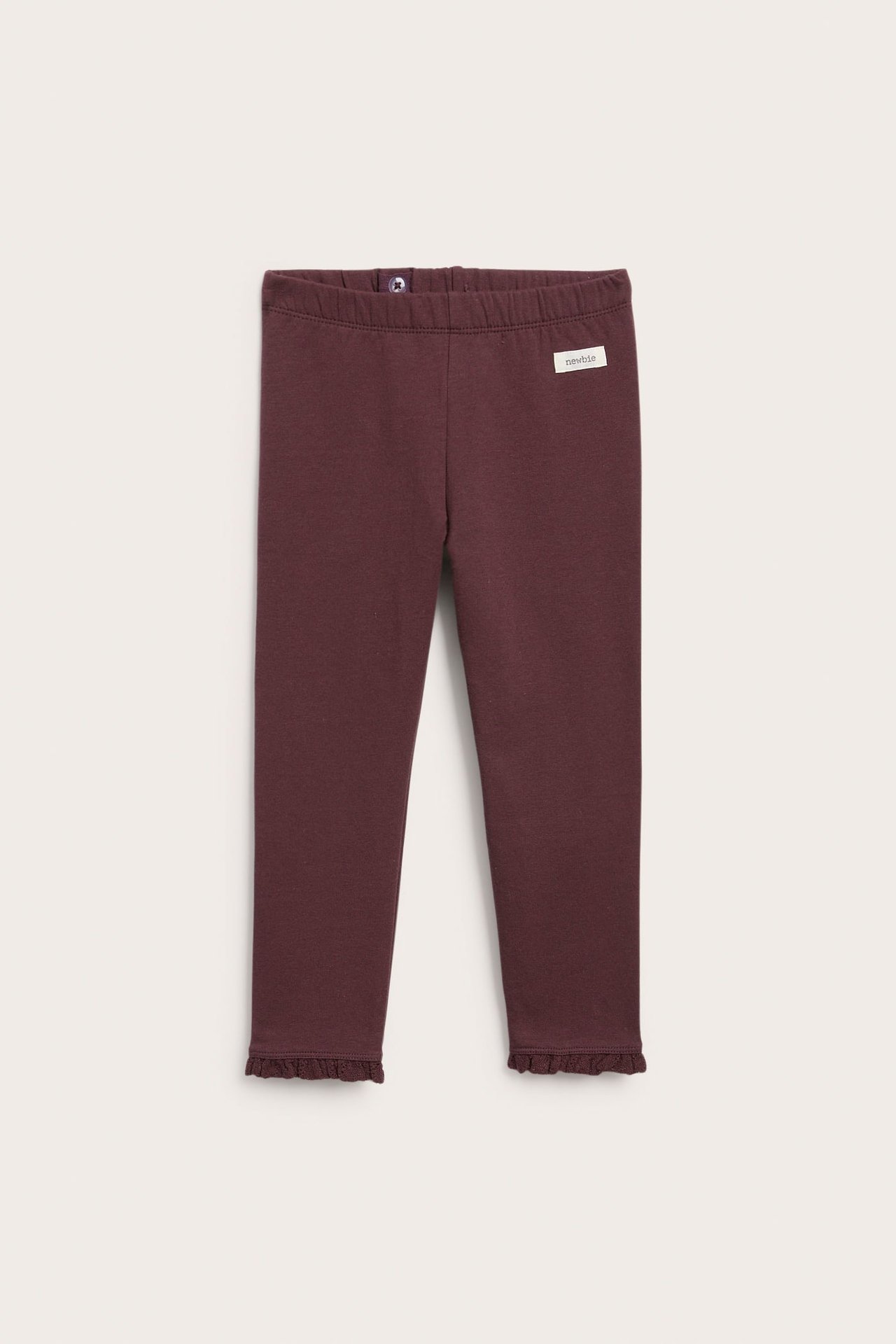Vorderansicht von dunkelroten Kinder-Leggings mit Gummibund und Rüschen am Saum.