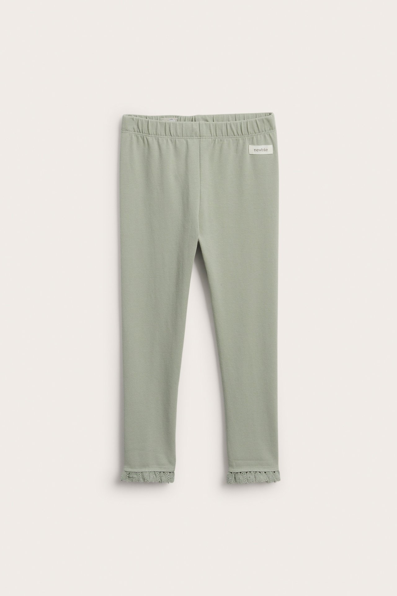 Front view of green cotton blend leggings with elastic waist and lace ruffle trim at ankles.
