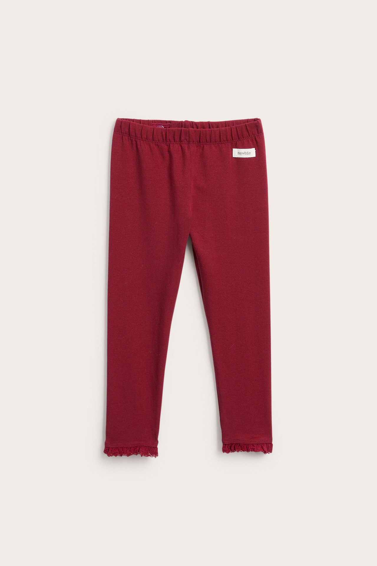 Vorderansicht roter Baby-Leggings mit Gummibund und Rüschen an den Knöcheln.