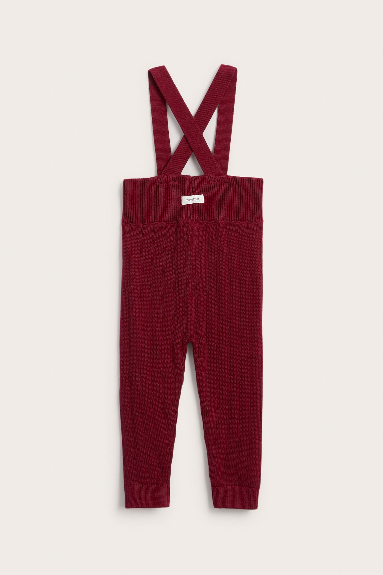 Front view: knitted burgundy baby overalls with criss-cross suspenders.