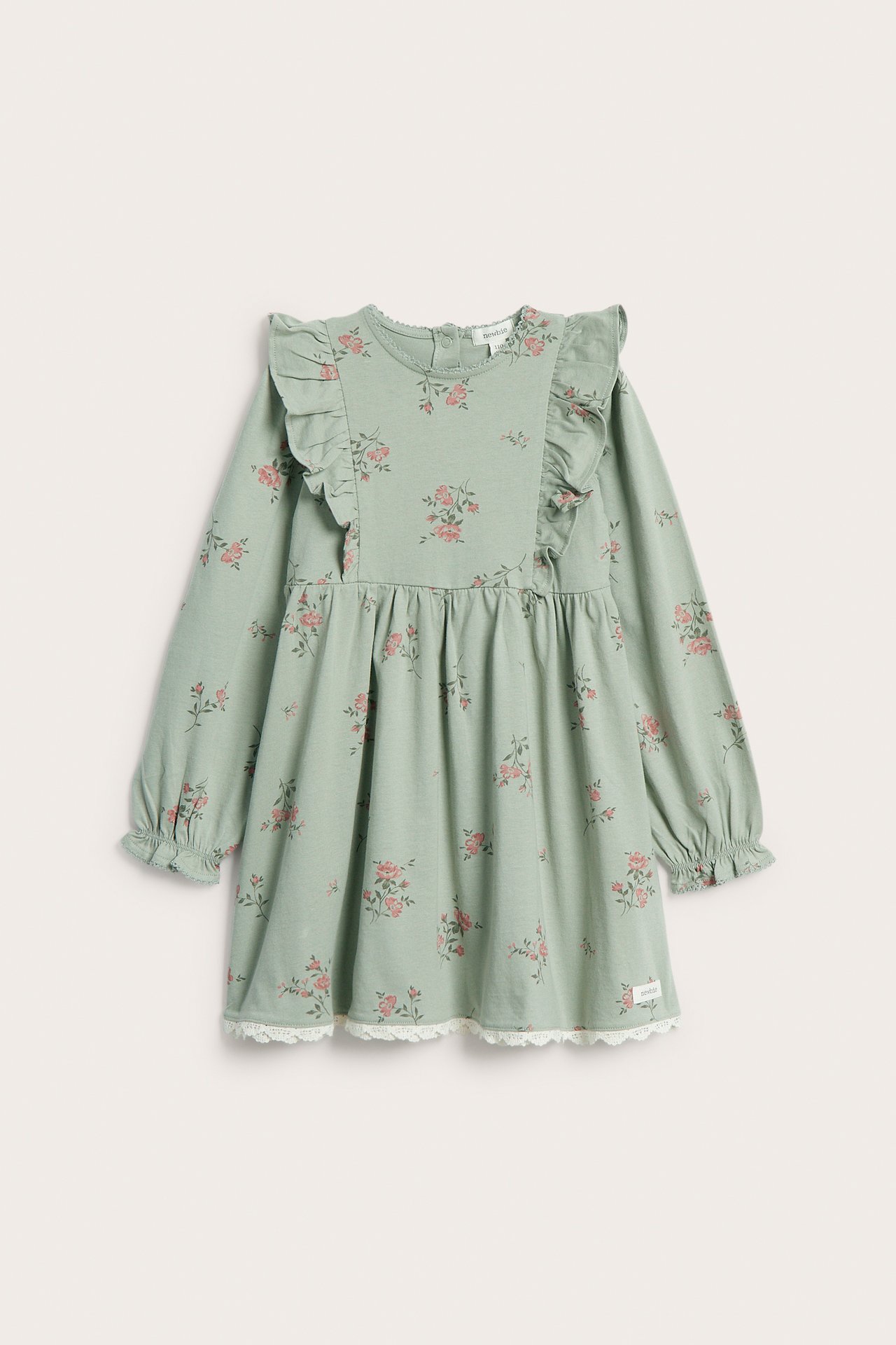 Front view: Kid's light green floral jersey dress with shoulder ruffles, ruffled cuffs, and white lace hem.