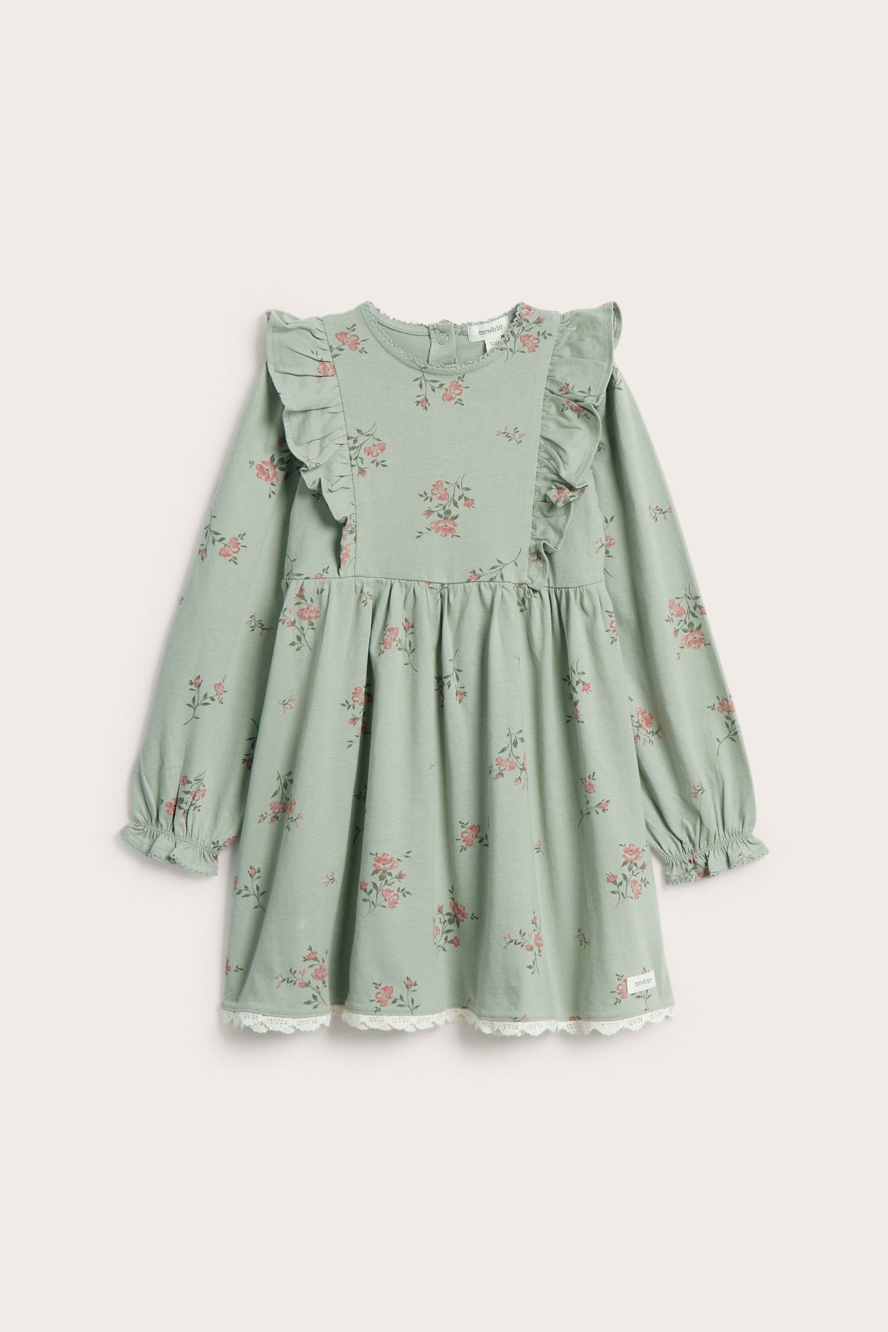 Front view: Kid's light green floral jersey dress with shoulder ruffles, ruffled cuffs, and white lace hem.