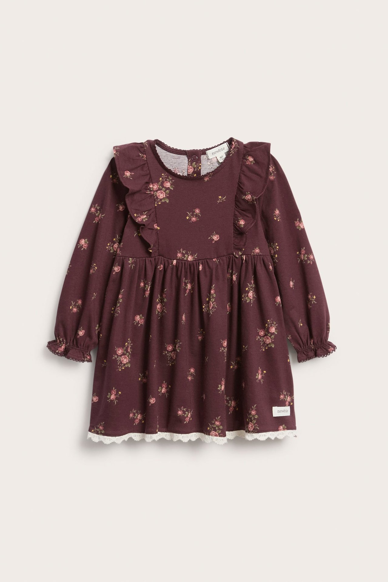 Vorderansicht, weinrotes Baby-/Kinder-Jerseykleid mit Blumenmuster, Schulterrüschen und weißer Spitzenborte am Saum.