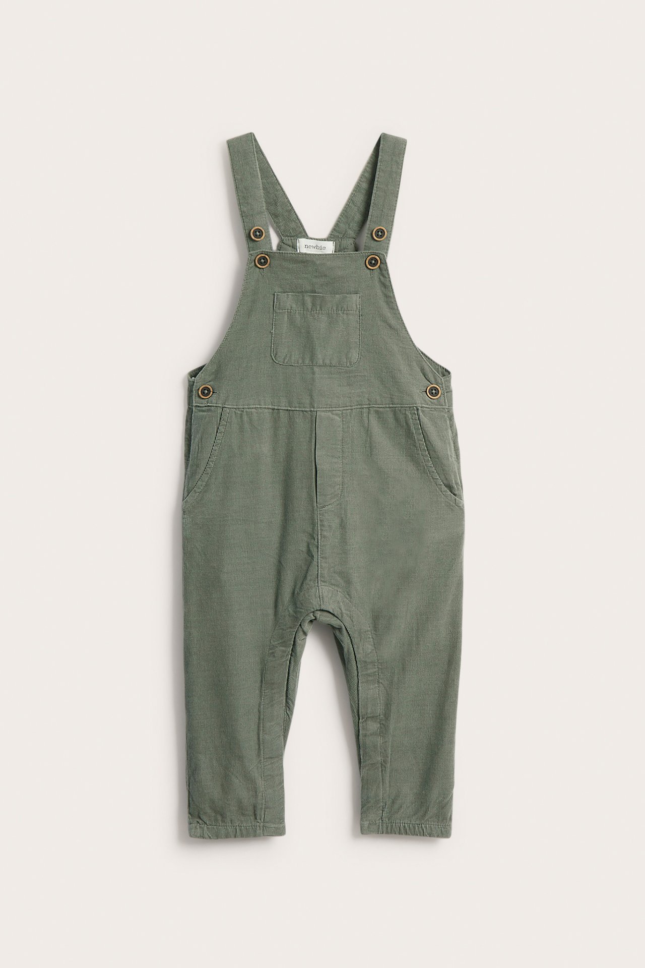 Front view of a baby's green corduroy overall with button fastenings.