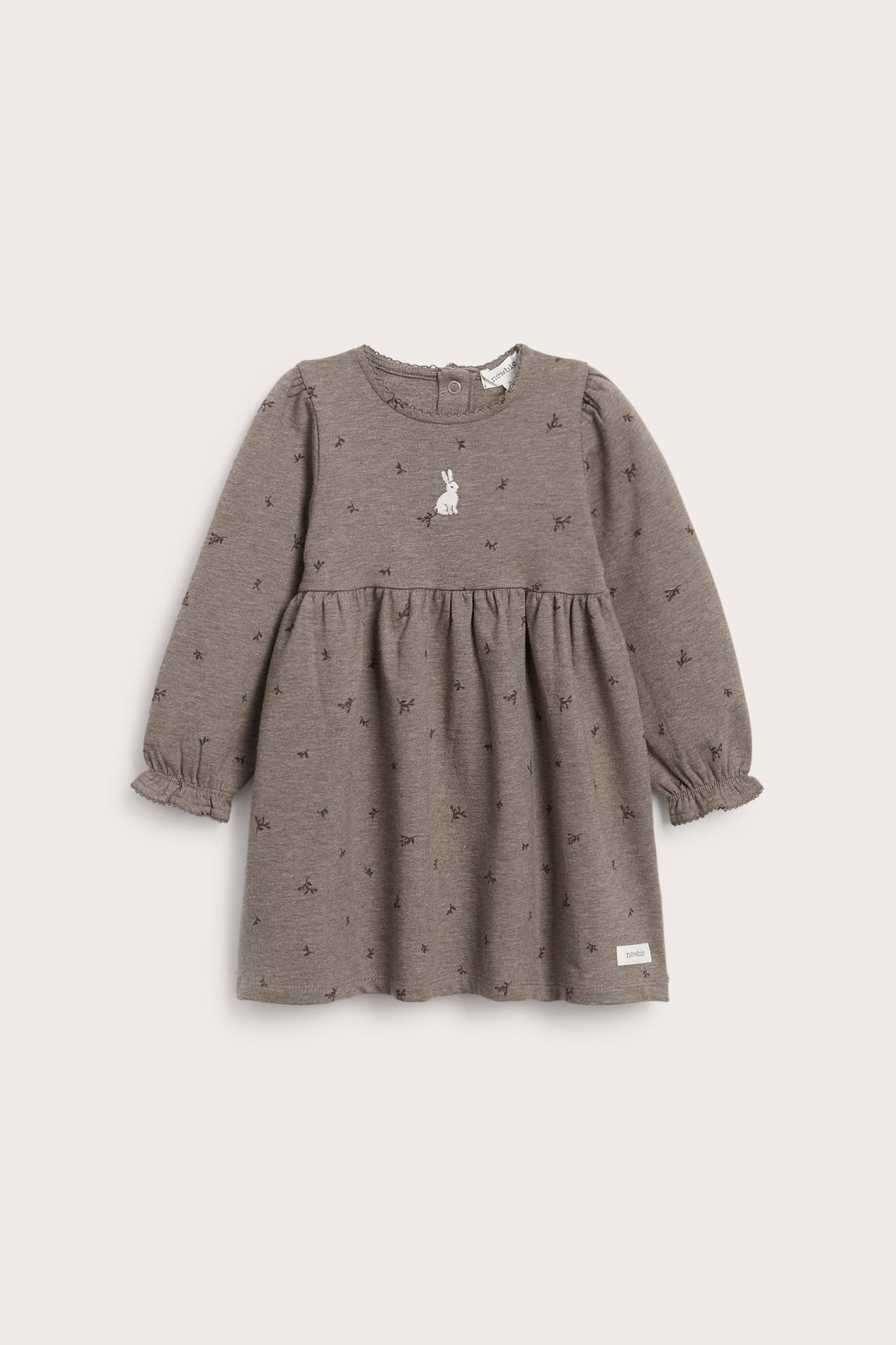 Front view of a brown long-sleeved baby dress with a white rabbit embroidery and small plant patterns.