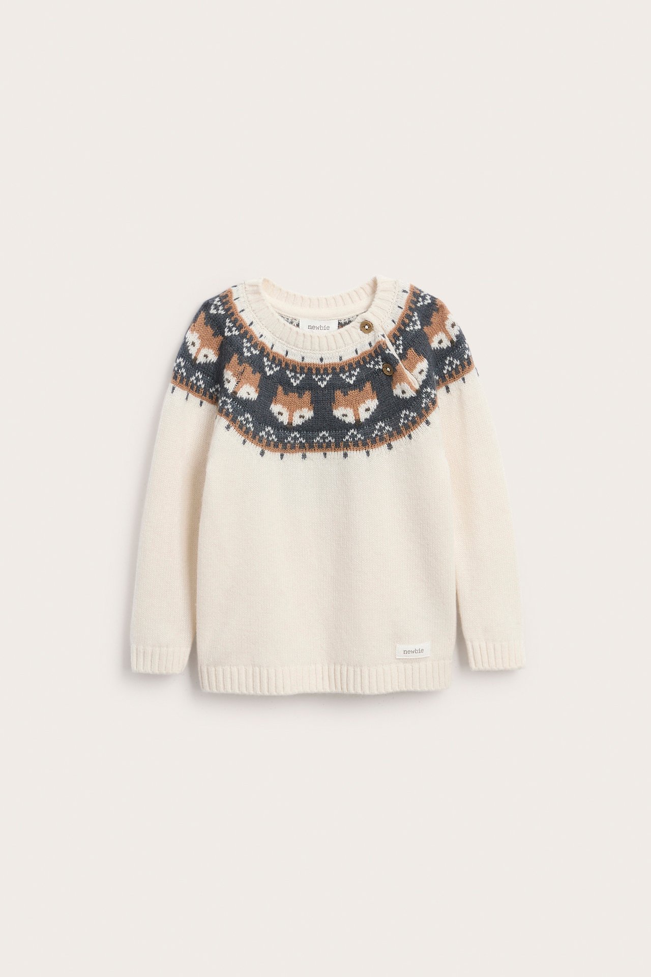 Front view of a baby's off-white fair isle sweater with brown and gray fox pattern and shoulder buttons.