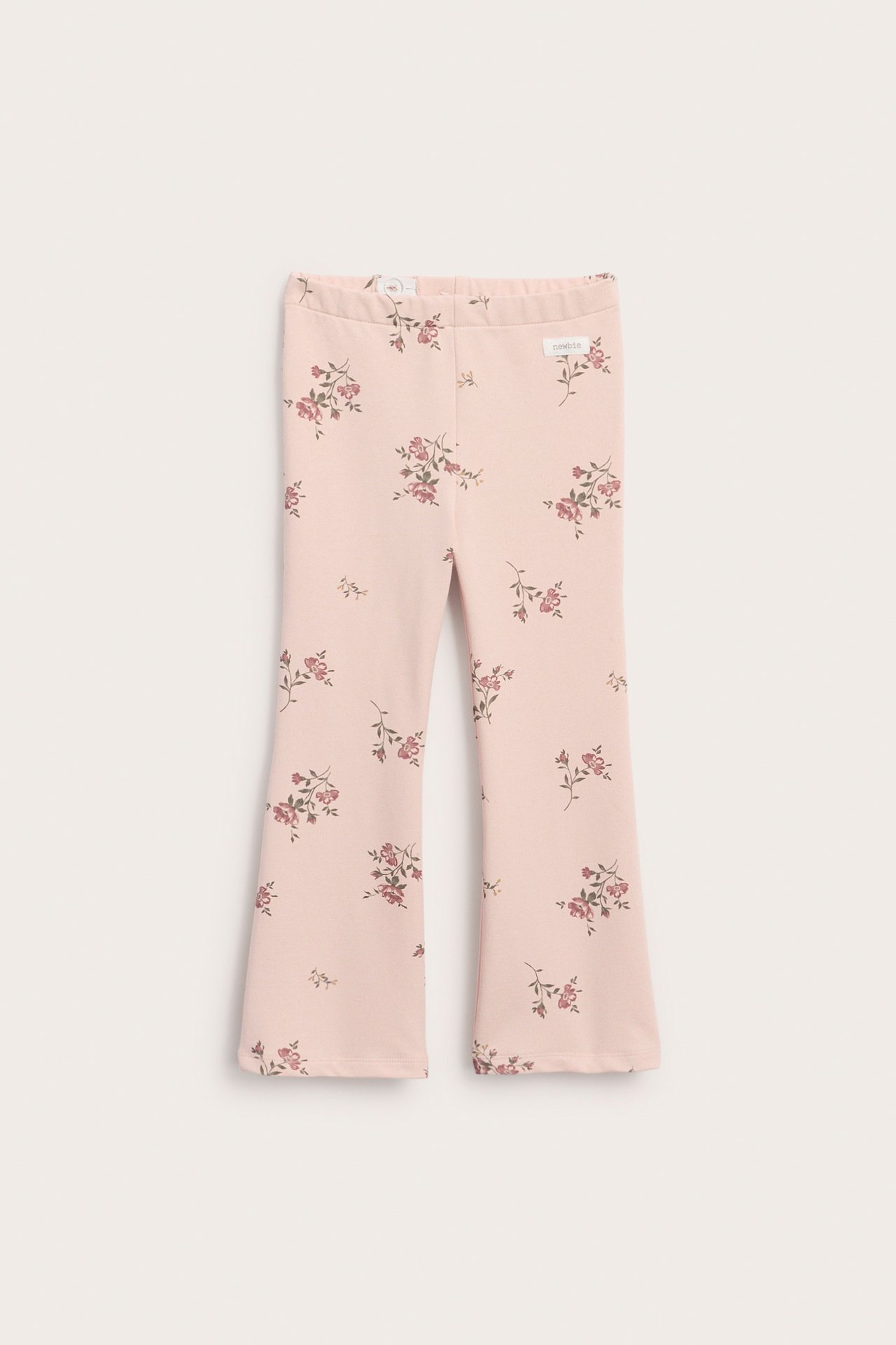 Light pink jersey flared trousers with a floral pattern and elastic waist, front view.