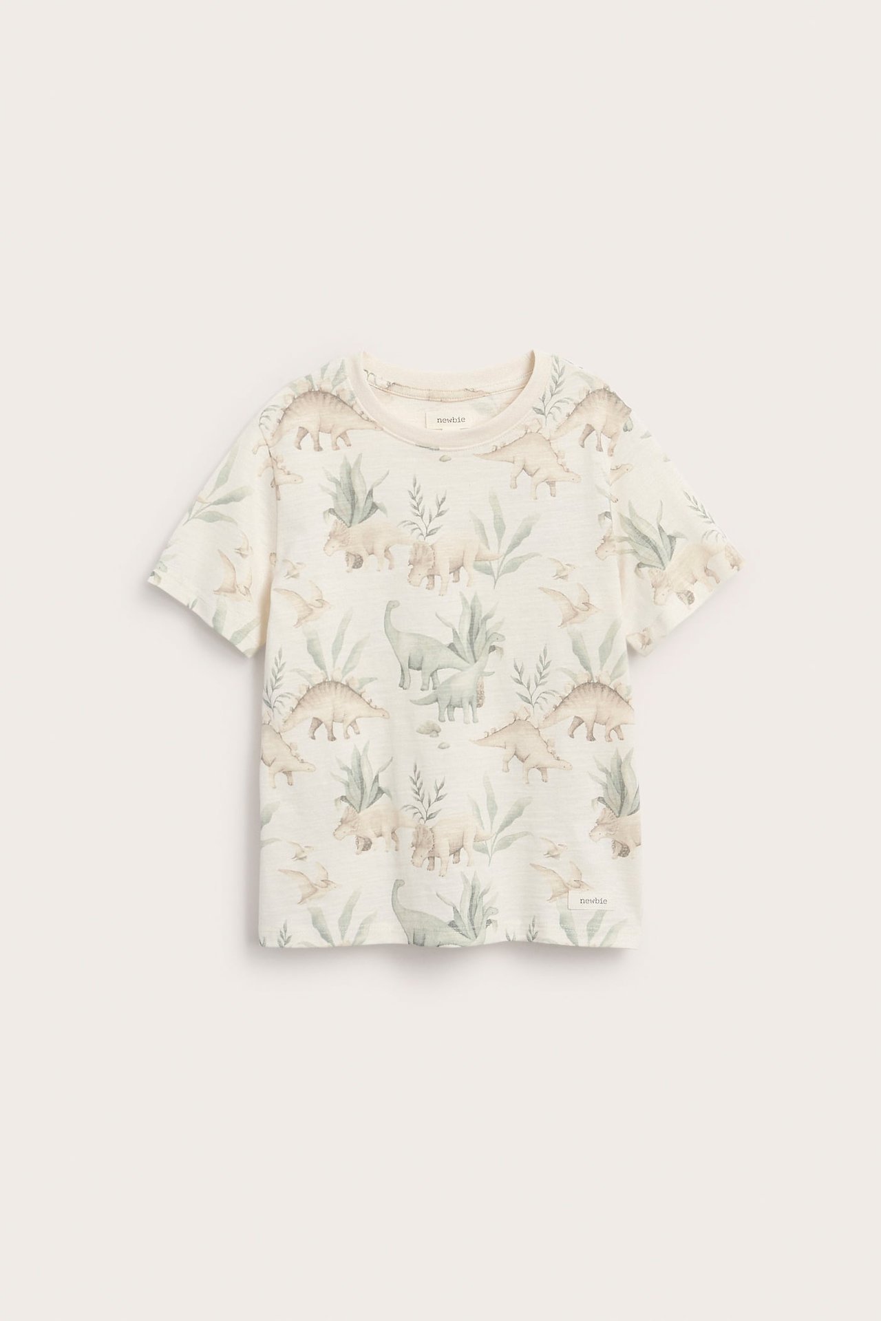 Vorderansicht eines cremefarbenen Kurzarm-T-Shirts für Kinder mit Dinosaurier- und Blättermuster.