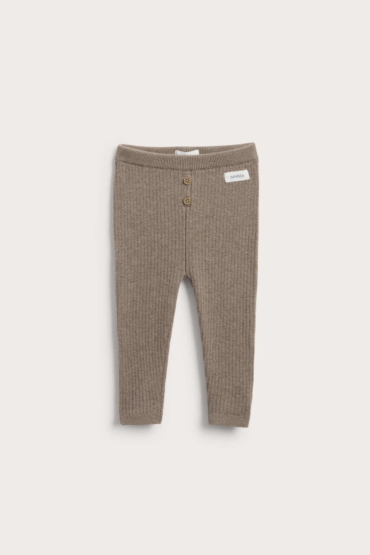 Front view of ribbed knit brown baby pants with two buttons at the waist.