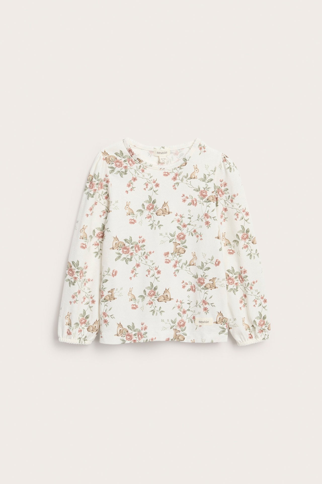 Front view of an off-white kid's long-sleeved jersey top with a deer and floral print, picot cuffs.