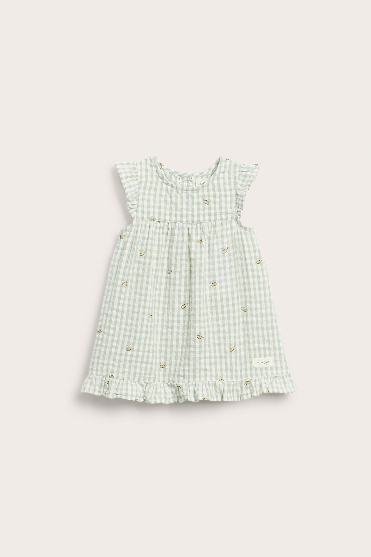 Front view of a kid's light green gingham dress with ruffled sleeves, embroidered details, and ruffled hem.