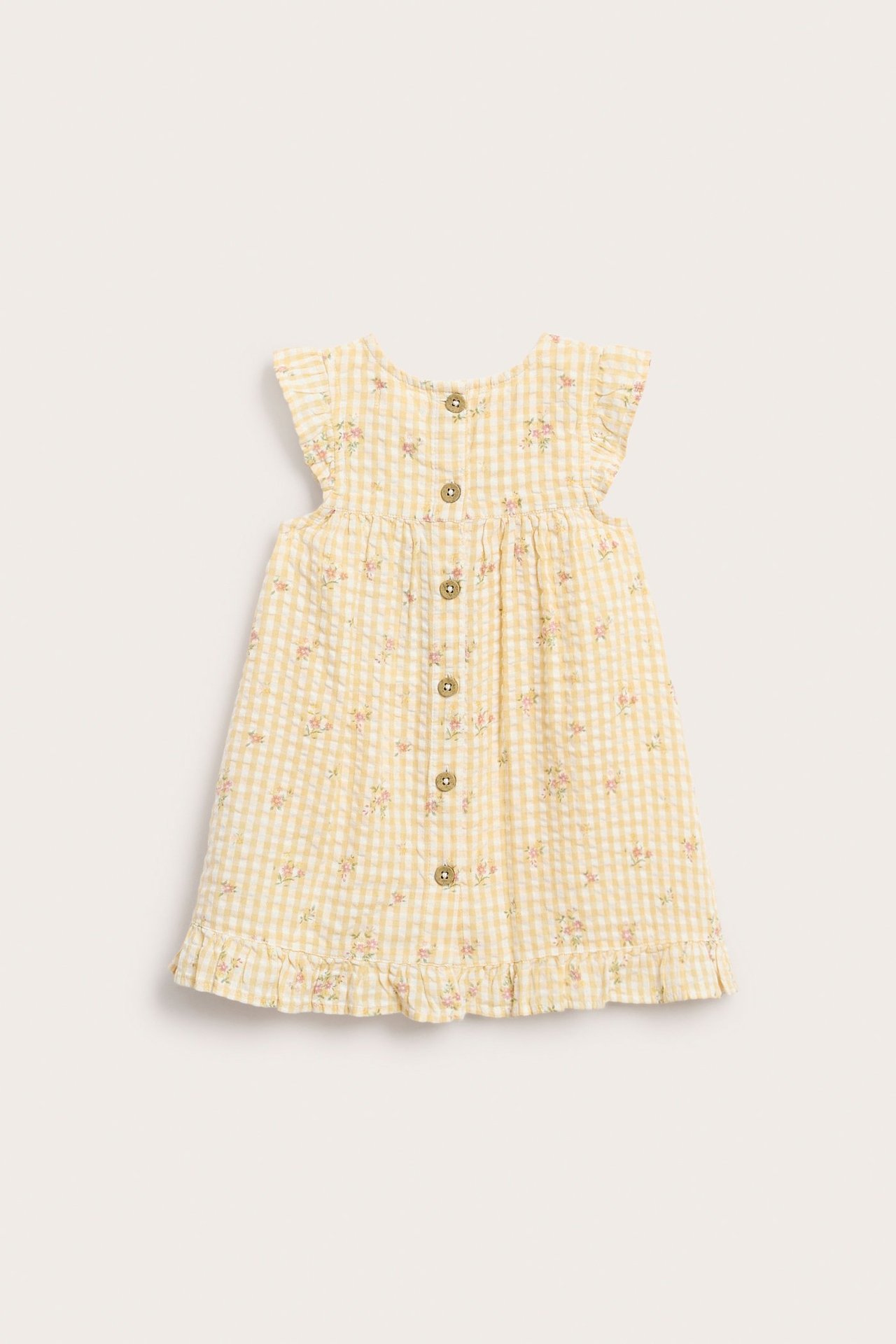 Back view of a baby's yellow gingham floral cotton dress with ruffled sleeves and back buttons.
