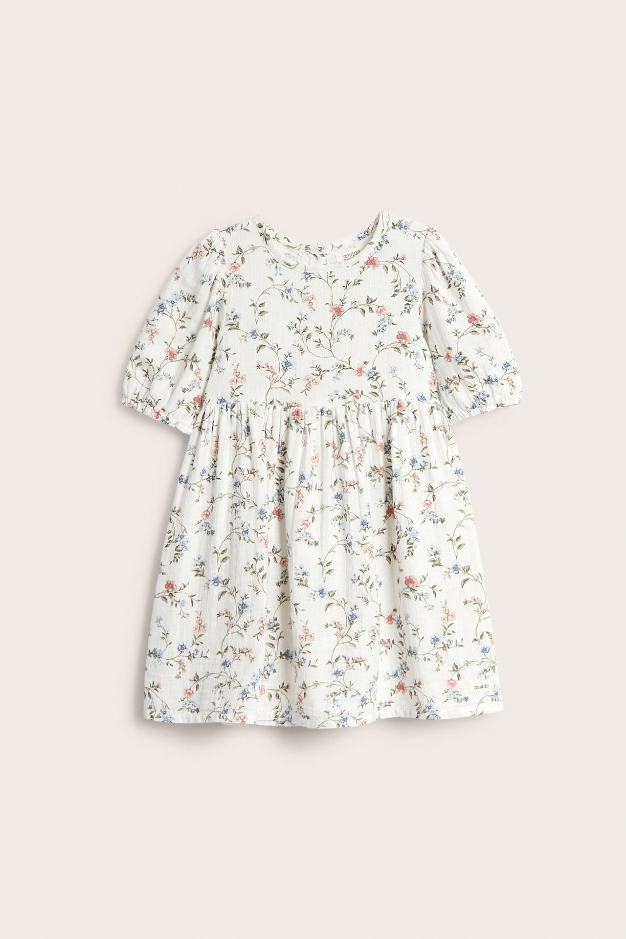 Front view of a kid's off-white floral dress with short puff sleeves and a gathered waist.