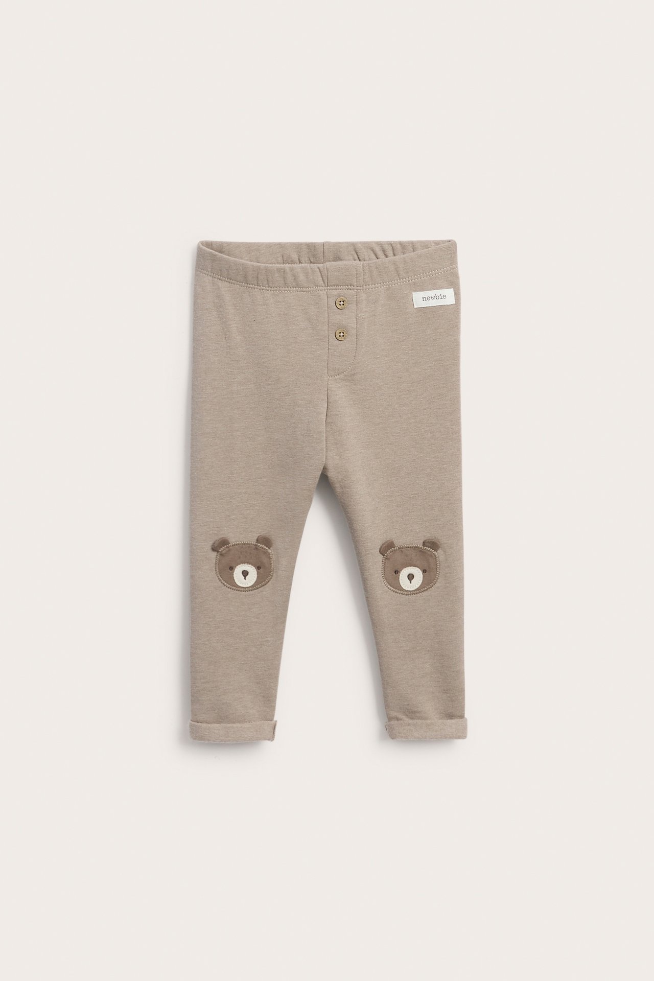 Front view of baby's light brown leggings with two front buttons and bear knee patches.