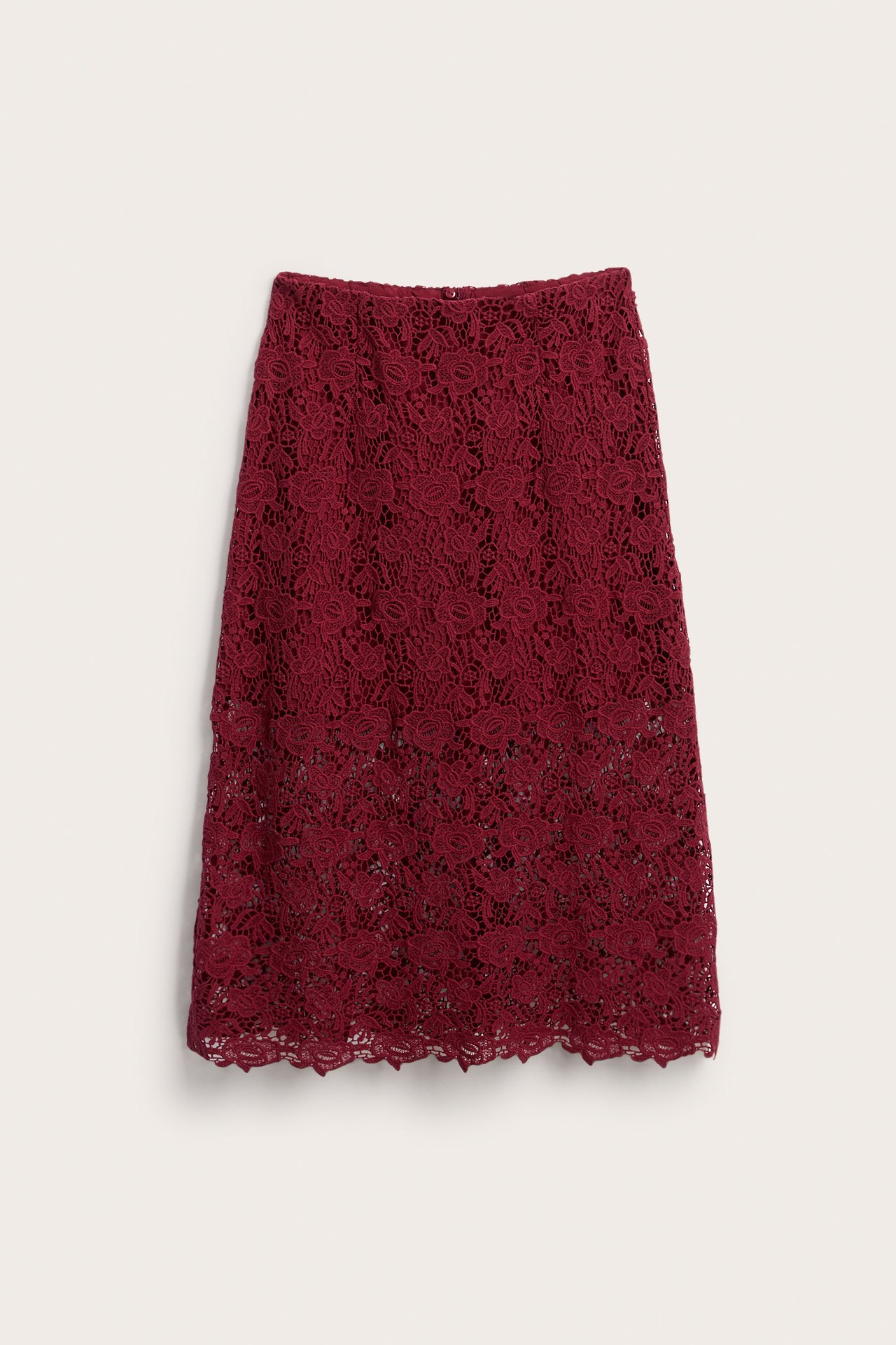 Front view of a burgundy lace midi skirt with a floral pattern and scalloped hem.