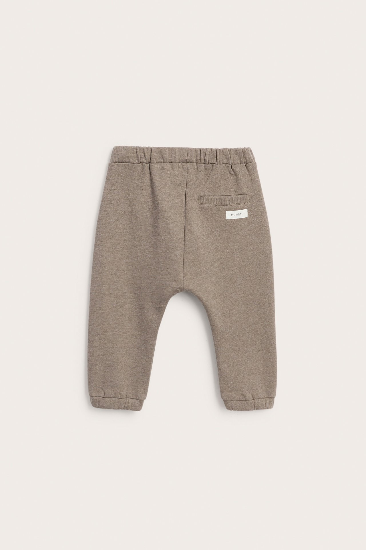 Back view of taupe baby sweatpants with an elastic waist and elastic cuffs.