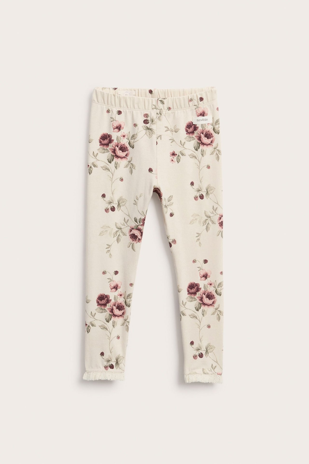 Vorderansicht: Baby-Leggings in Creme mit Blumenmuster, rosa Rosen, Beeren und Gummibund.