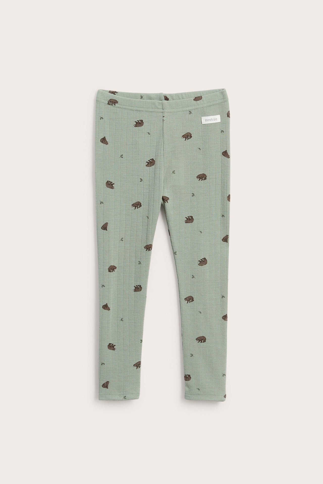 Front view of ribbed light green baby leggings with brown bear and tiny leaf patterns.