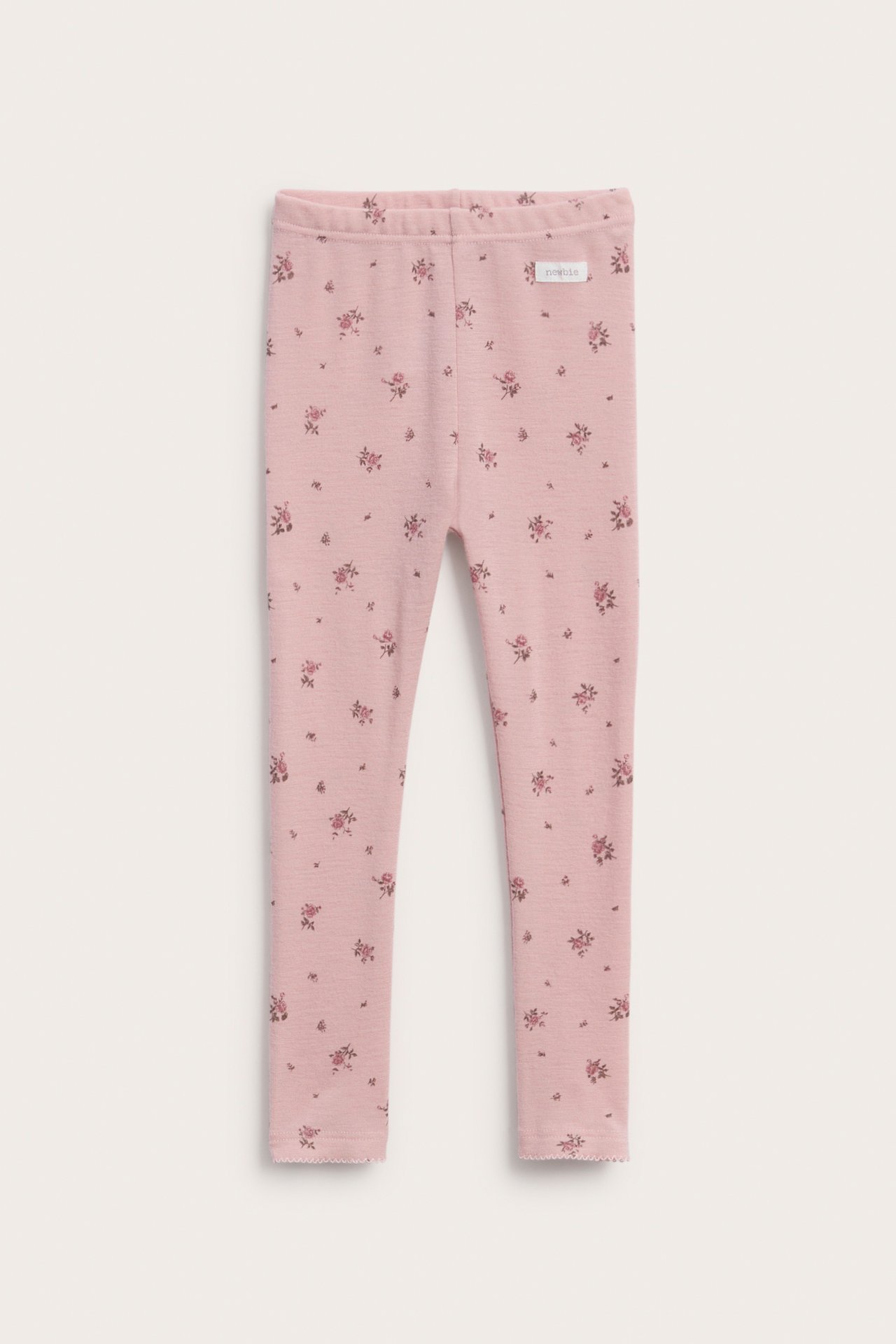 Front view of pink baby leggings with an elastic waistband and all-over small floral print.