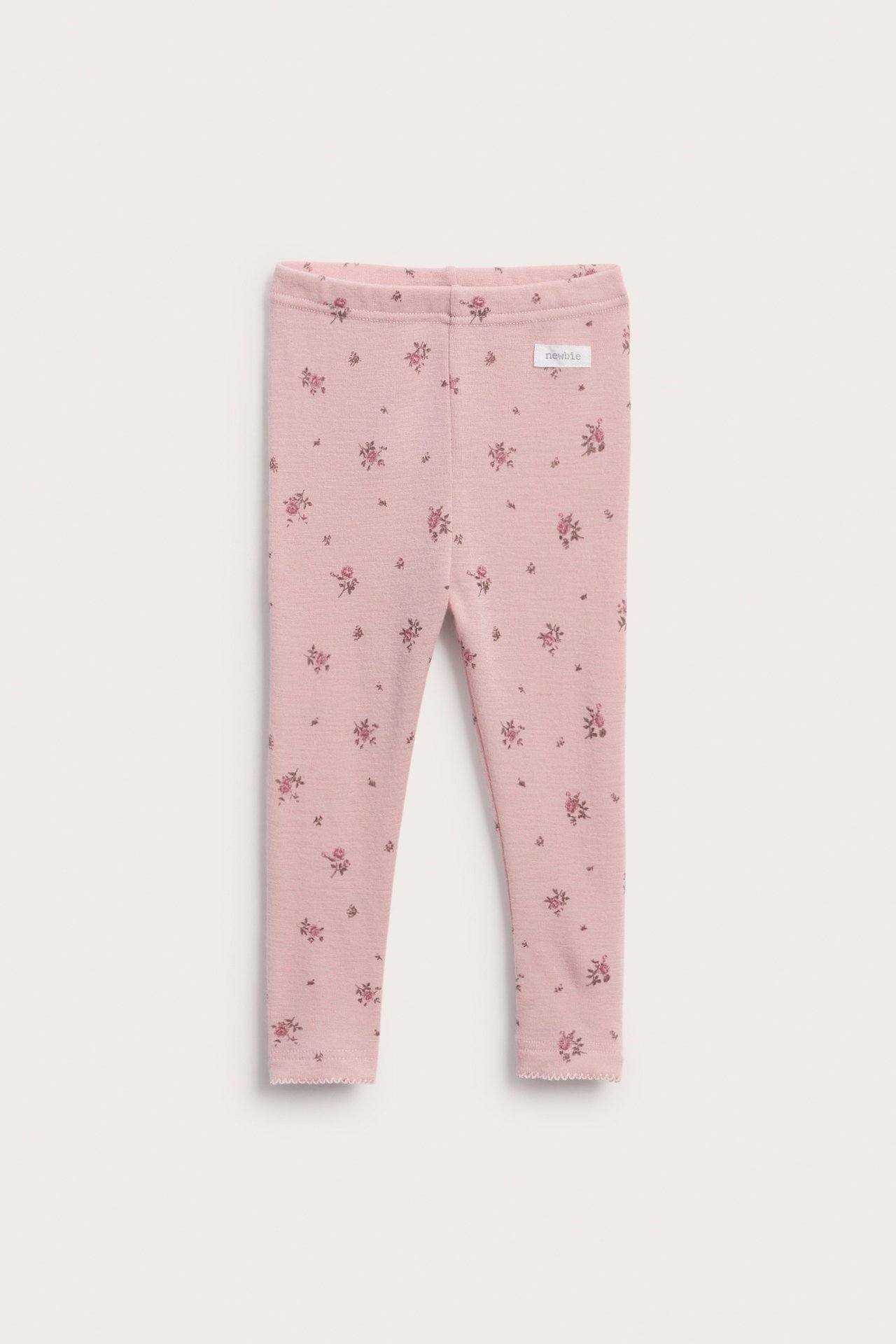 Rosa Baby-Leggings mit Blumenmuster, Vorderansicht, mit gewelltem Saum.