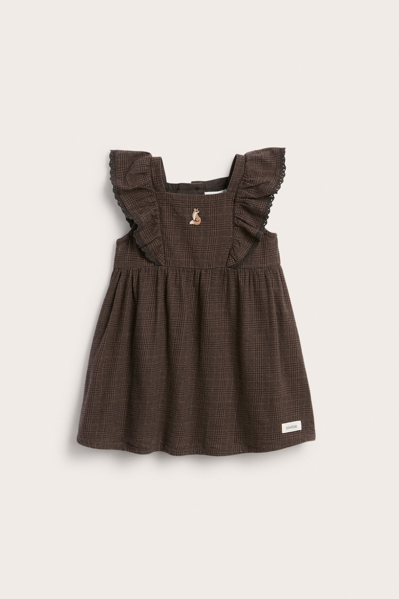 Front view of a baby's brown plaid pinafore dress with ruffled straps and a fox embroidery.