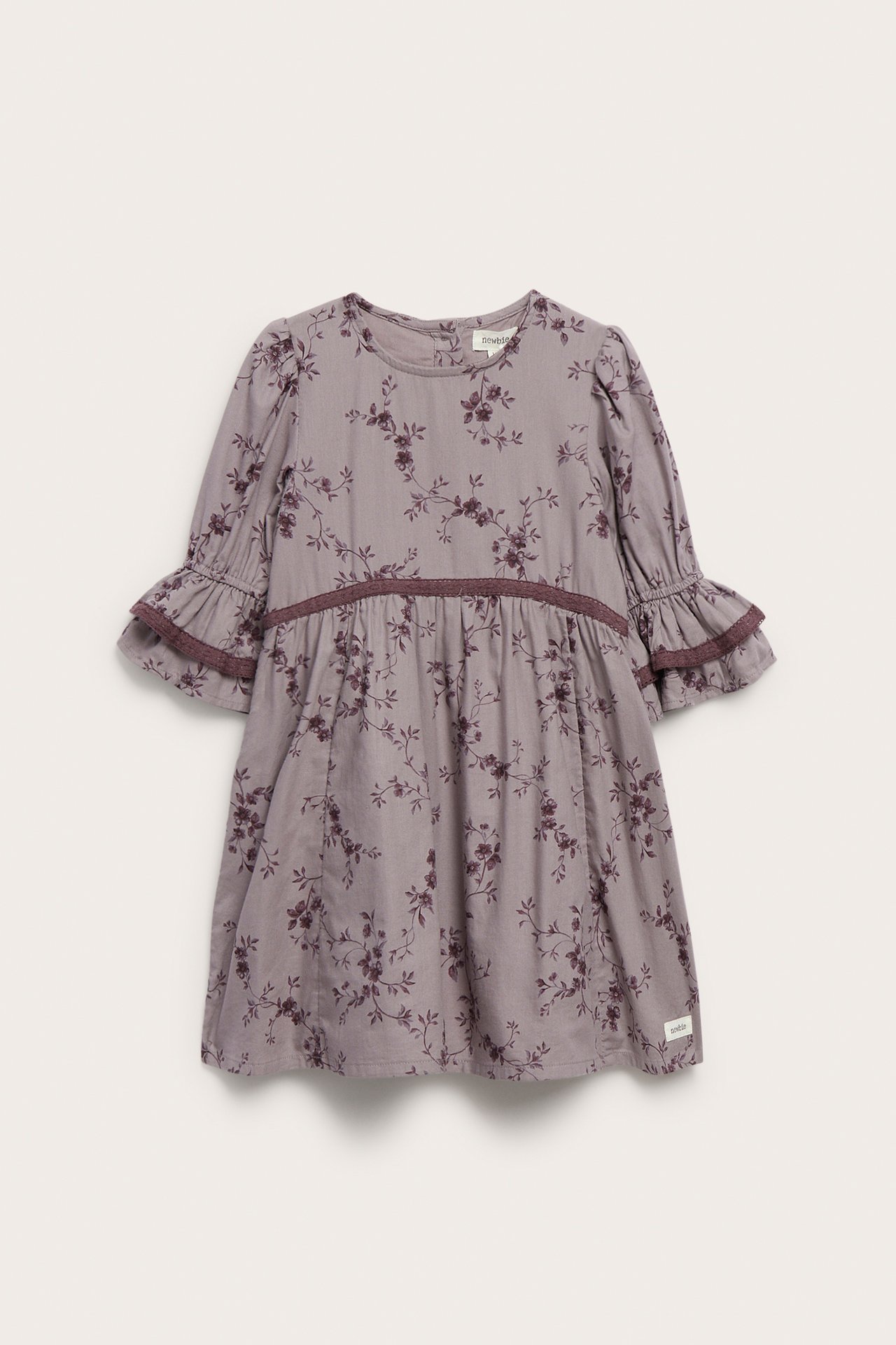 Front view of a kid's purple floral print dress with ruffled sleeves and waist trim.
