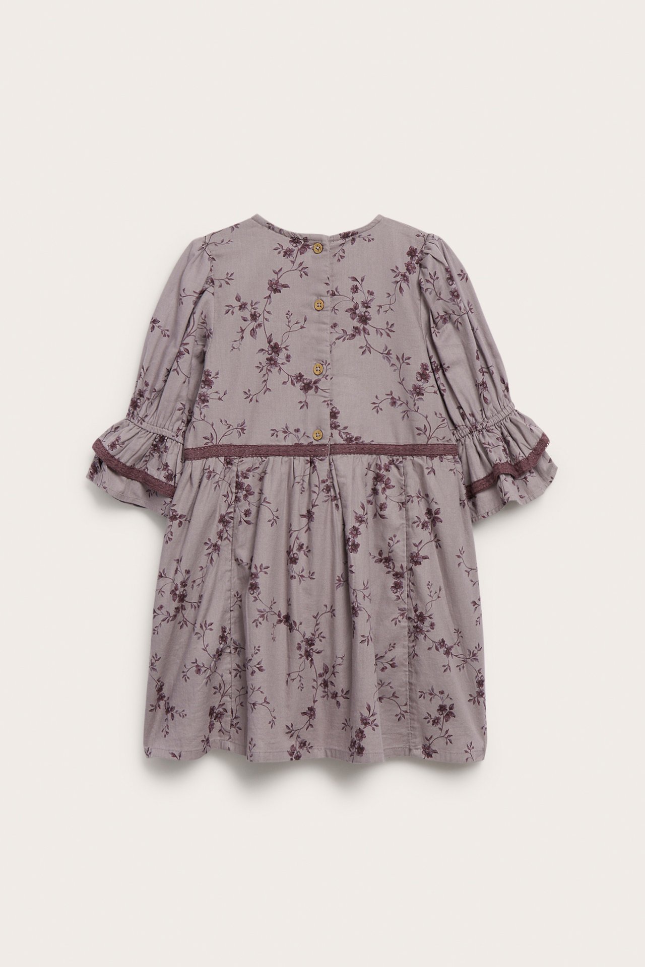 Back view of a kid's gray-purple floral print dress with long ruffled sleeves.