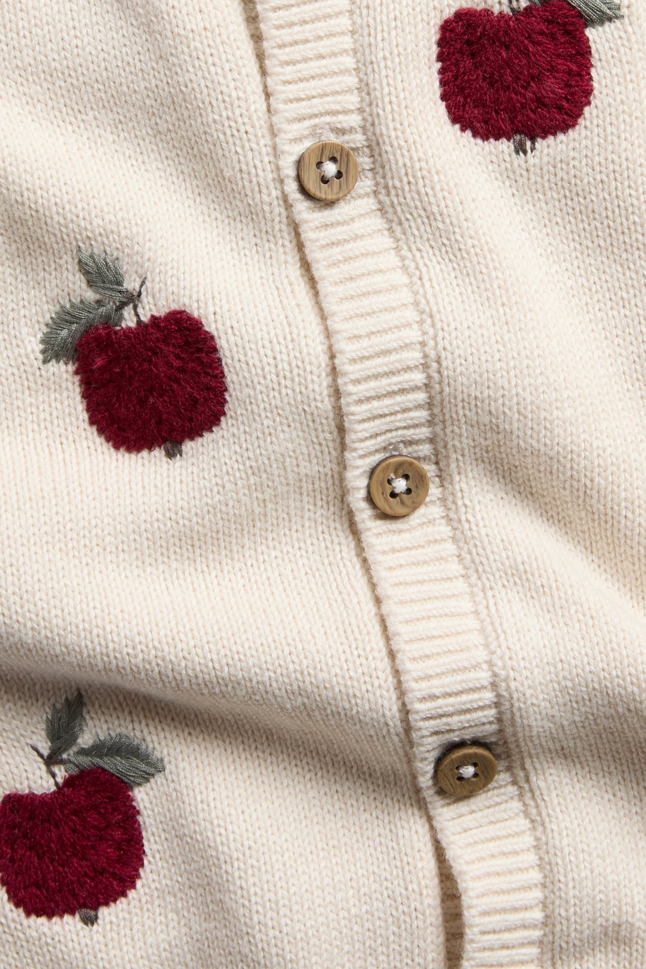 Knitted cardigan with embroidered apple