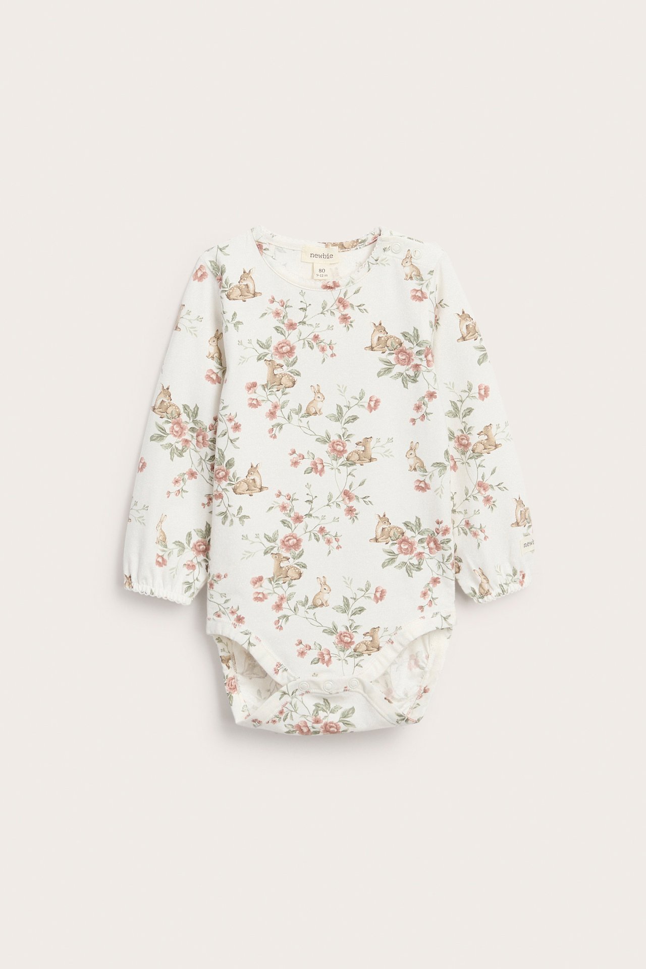 Front view of an off-white jersey baby long-sleeved bodysuit with deer and floral print, snap buttons.