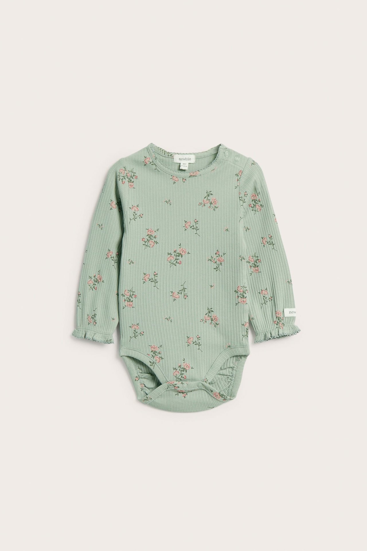 Front view of a baby's long-sleeved light green ribbed bodysuit with pink floral print and snap buttons.