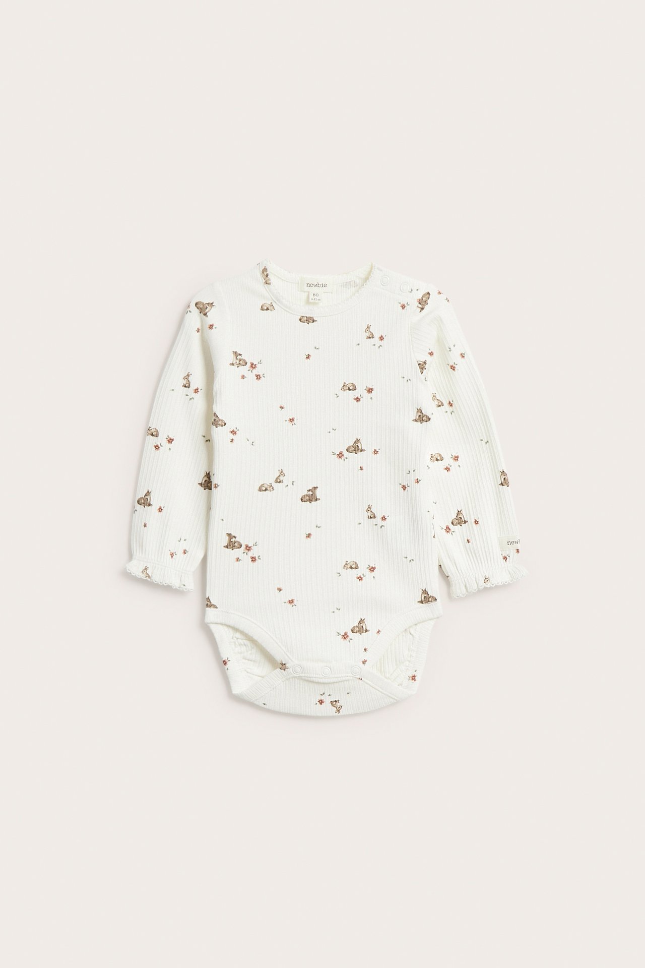 Front view of an off-white ribbed baby bodysuit with a deer and floral print, picot edges, and wrist frills.