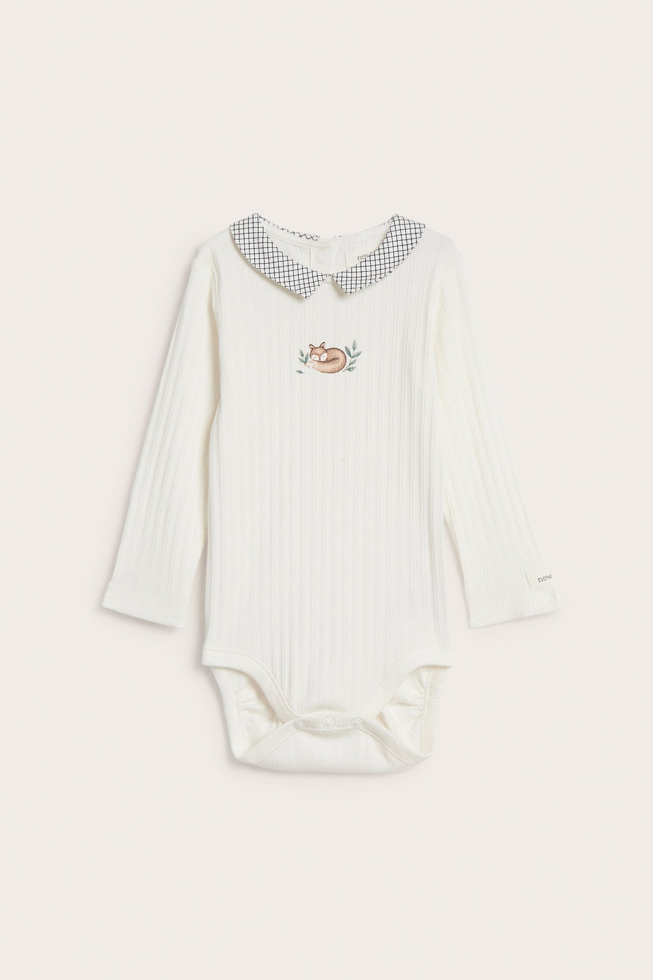 Front view of a baby's cream ribbed long-sleeve bodysuit with a checkered collar and fox embroidery.