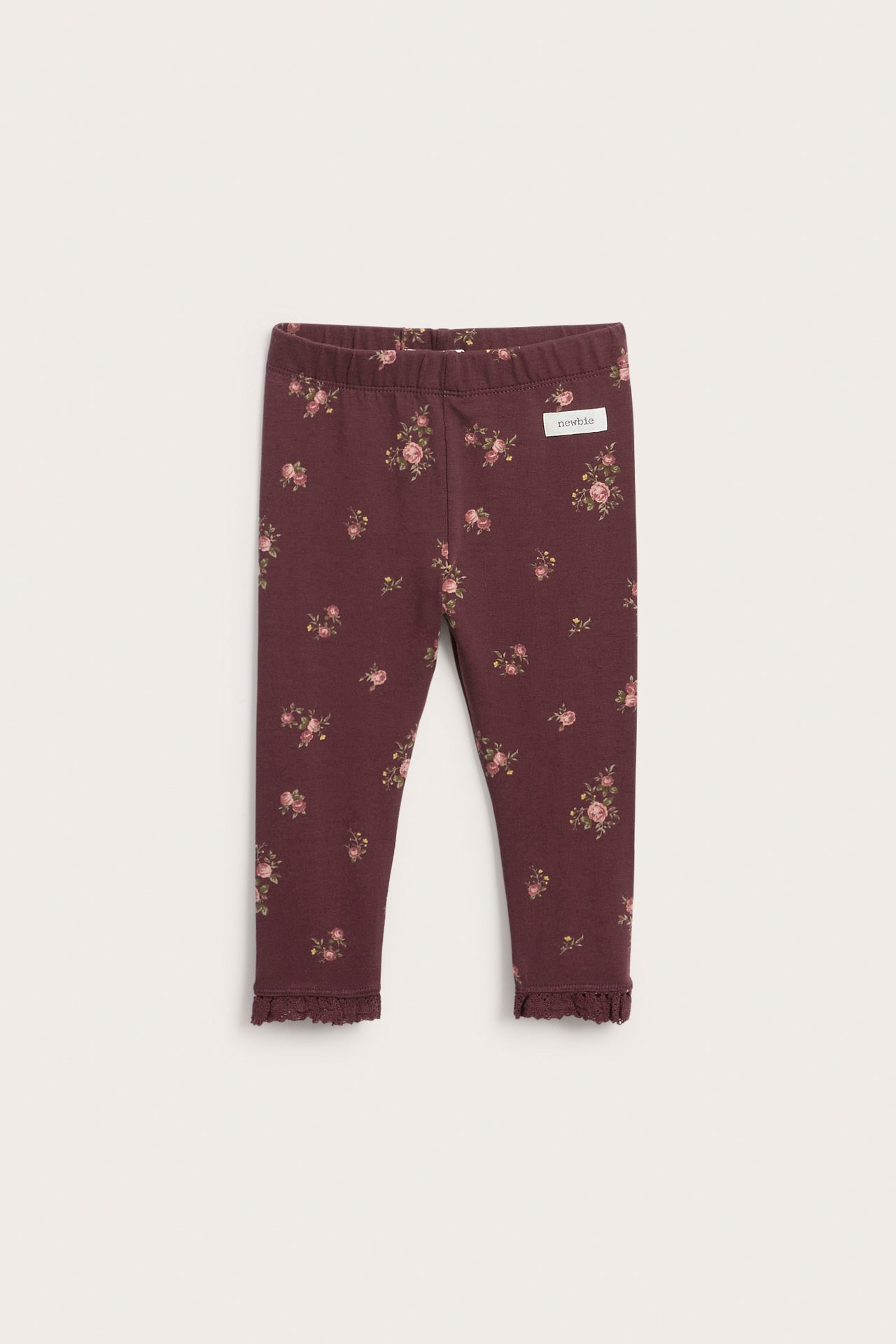Front view of dark red floral baby leggings with ruffled hems.